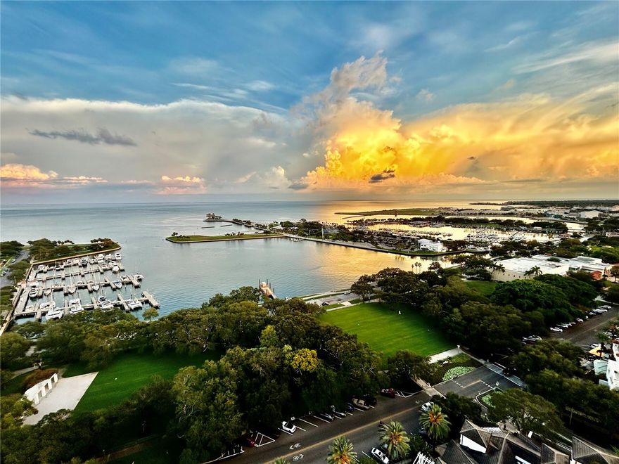 INCREDIBLE PANORAMIC VIEWS await you from the 22nd floor at this impressive 400 Beach Drive residence. The most sought after of residences in DTSP.  Take the elevator directly into the foyer with a timeless chandelier to welcome you home.  At the end of the grand entrance hall you will be amazed by the most impressive views in the living space/kitchen and balcony of the Bay, Pier, green space, Vinoy, sail boats, private airplanes and more. The UPDATED, modern, custom kitchen features automatic upper cabinets, double depth lower drawers, a double beverage cooler, built-in Miele coffee maker, pantry with pull-out drawers, Miele dishwasher, stainless fridge, built-in oven, induction cooktop, strip outlets underneath upper cabinets and underneath the island counter, glass tile back splash, quartz counters and a custom bar that has a dimmer switch to light up (perfect for night time).  Step outside the sliding door to the LARGE, COVERED BALCONY facing directly East towards the pier with stunning views to the North and South as well.  The 3 total bedrooms are nicely separated from each-other and all have UPDATED, ensuite full bathrooms. The master-suite is the definition of magnificence with a large ensuite bathroom featuring, high-end lighting features, lighted mirrors, custom cabinets, high-end fixtures, in-drawer outlets, separate shower, a deep garden tub and separate toilet room with pocket door for privacy. Master also features a large walk- in closet and another closet with mirrored doors in the hallway.  New plush carpet, access to the balcony and views that face the pier and Bay. The 2nd bedroom with ensuite full bath is spacious with views of green space and the Bay and has 2 closets as well as built in storage cabinets. The 3rd bedroom with ensuite bath features built in cabinets for storage, views of green space and the Bay and is down a separate hallway as you pass the inside laundry and utility room.  The pictures speak for itself but you have to see this in person to truly appreciate how absolutely breathtaking every inch of this luxury, single story living unit is and the views that nearly every room has to offer. Unit 2203 also comes with 2 parking spaces, 1 with an electric car charger located on the 3rd floor of the parking garage. Also on the 3rd floor is an air-conditioned, storage cage.  The community has 365/24/7 concierge, resort-style pool, three dry cleaning services, social room w/ billiard tables, UPDATED state-of-the-art fitness center, building social activities, & more! Live among St. Pete’s trendy restaurants, museums, theaters, parks, shops and the brand new $92M St. Pete Pier! ADDED BONUS: 400 Beach restaurant is under renovation and menu changes which will add even more beauty and desire to this prime location.  Other; Water softener 2021, zoned HVAC systems 2015 and 2019 with new electronic air purifiers. Schedule a showing today to see this spectacular property for yourself. Virtual walkthrough available upon request.