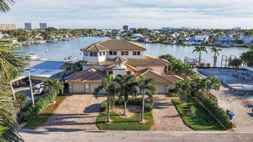 Welcome to Yacht Club Estates! This 3-bedroom, 3-bath home private office home offers over 3,600 sq. ft. of waterfront living on a rare cul-de-sac lot with 100 feet of waterfront. Enjoy a custom dock with a 32’ lift, water, electric, solar lighting, and a newer seawall (2019). Built with 2x6 insulated walls and impact windows, the home is elevated so the main living areas stayed dry during recent storms.Inside, you’ll find open living and dining areas that lead to a large waterfront terrace—perfect for entertaining. The kitchen features Viking appliances, quartzite countertops, a wine cooler, and an ice maker. The entire upper level is a private owner’s suite with a balcony, dual closets, and a spa-style bathroom.Additional features include two guest bedrooms, a dedicated office, a heated saltwater pool, and two 2-car garages. With direct access to Boca Ciega Bay, the Gulf, nearby beaches and downtown St. Pete, this home offers the best of waterfront living.