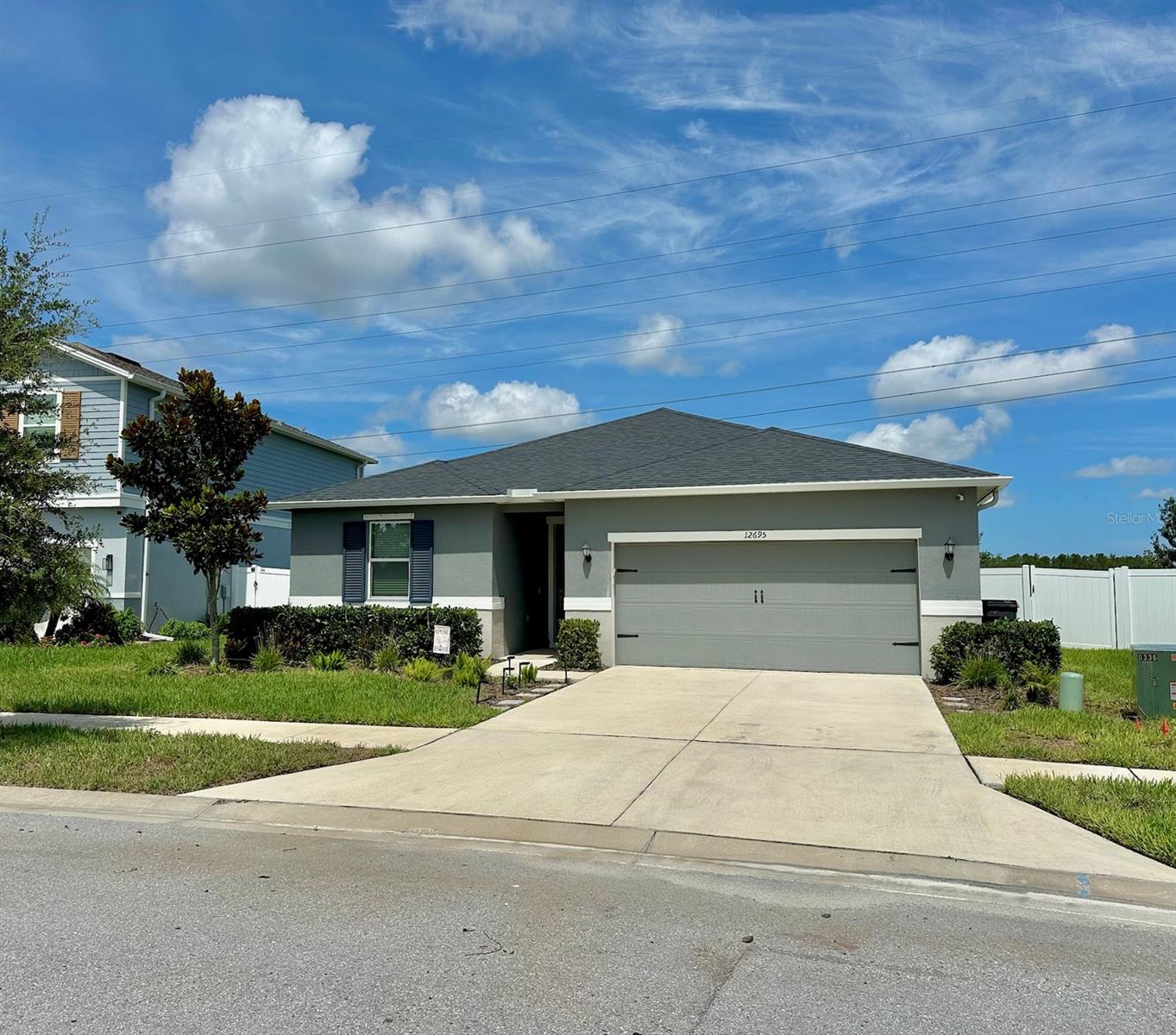 This charming one-story home offers 1,983 square feet of comfortable living with 4 bedrooms, 2 bathrooms, and a 2-car garage. Step inside to find a bright, open-concept layout that seamlessly connects the kitchen, dining area, and family room, perfect for everyday living and entertaining guests. The kitchen features granite countertops, stainless steel appliances, a large island overlooking the family room, and 42-inch upper cabinets. This home is a split concept plan with a spacious owner’s suite that serves as a serene retreat, complete with a walk-in closet and an en-suite bathroom featuring a beautifully tiled walk-in shower with a built-in bench, and linen closet for added convenience. The additional three bedrooms offer flexible space for family, guests, or a home office. The guest bathroom features a large granite countertop with vanity area. Outside, relax on your patio with peaceful views perfect for enjoying Florida’s sunny days. The home has hurricane shutters. Located near FL-589 Suncoast Parkway, shopping, dining, medical facilities, local beaches, lakes, and wildlife refuges, this home offers easy access to everything you need. Why wait for new construction with high CDD fees when you can move into this move in ready property with NO CDD fees.