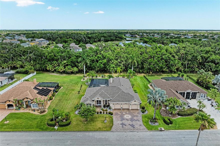 VERY LOW HOA and NO CDD FEE! This exceptional one level home offers a rare and highly desirable MOTHER IN LAW SUITE OPTION with it's own private entrance, flexible enough to accommodate either a 1 or 2 bedroom setup. Complete with a full bath and spacious walk in closets. This unique feature sets the home apart from the rest. Over 3,000 sq foot of beautifully designed living space with 5 bedrooms and 3 baths it's perfectly situated on nearly 1/2 acre of land. 
The spacious kitchen is designed for gathering and entertaining, featuring a large eat in bar, small kitchen nook area, a larger formal dining space and double convection ovens perfect for home chefs and holiday entertaining. A warm gas fireplace adds charm and comfort to the main living areas. Step outside to your private backyard retreat with peaceful conservation tree views, a sparkling salt water lap pool, and outdoor shower that creates the perfect Florida lifestyle experience.
The expansive backyard complete with an outdoor kitchen set up, ideal for, relaxing or creating your own outdoor oasis. The oversized triple car garage provides ample storage and room for vehicles and toys.
A truly must see home!  Buyer to verify all measurements and HOA Rules