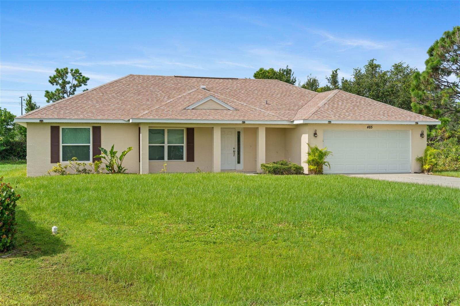 Welcome to 485 Santiguay street, located in one of the most popular subdivisions in all of Charlotte County, Deep Creek , a deed restricted community. Enjoy the comfort in knowing you are in one of the highest above sea-level areas in all of Charlotte County. This 3 bed, 2 bath home is guaranteed to charm you with its rich-toned laminate floors, cathedral ceilings, stylish kitchen, and bright interior. Step inside and notice immediately how much light is let through by multiple windows and double doors. You'll find no shortage of space in the living room area, and neutral tones give freedom for any style of decor you choose. In the kitchen, handsome cabinets and hanging overhead lights provide a chic atmosphere to prepare all your favorite meals, and the eating bar/ventilation hood sweeten the deal! The primary bathroom contains double sinks with double mirrors, and a walk-in shower with a rectangular metal showerhead; and the tray ceiling in the primary bedroom lends a spacious feeling.
Located in Deep Creek (a quiet subdivision with an active community and attractive, well-kept appearance), with nearby access to parks, schools, medical facilities, and shopping, 485 Santiguay provides you can't pass up the opportunity to see in person!