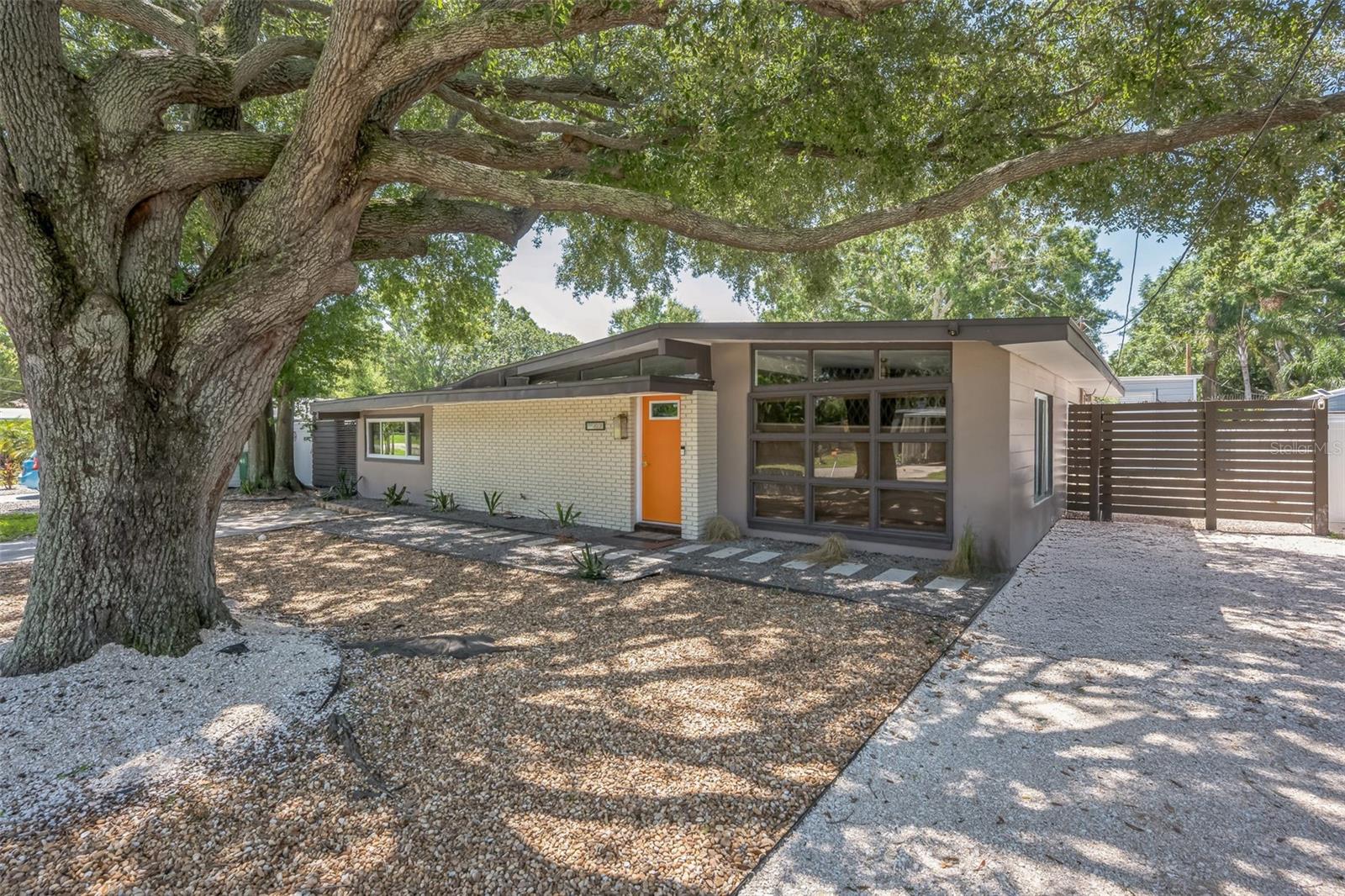 Don’t miss out on this newly renovated Mid-Century ranch with modern amenities and an outdoor paradise; close to both the water and everything Tampa has to offer! This one of a kind 3 bedroom plus den, 3 bath house is situated on an over-sized lot complete with everything an active outdoor lifestyle needs – an extra large 32x16 garage/shop with loft and 14 ft ceilings, a stand-alone office overlooking the salt-water pool, a newly re-screened patio and plenty of lounging areas in between its grand oaks and palm tree- all on a lot just under a quarter acre for ample space and privacy. The interior boasts a modern refreshed feel throughout; highlighted by a new oversized kitchen with 14 ft black quartz single slab marbled eat-in countertop and flat paneled honey oak cabinets with stainless steel appliances and a large pantry. New Roof, high-impact storm windows in 2025. New AC in 2024. New Plumbing in 2024 (re-drained in 2025). Electrical panels have been updated in the past 5 years as well. Formal living room, dining area, plus a spacious family room perfect for gatherings. Situated in the Sun Bay South neighborhood, just minutes from MacDill Air Force Base, shopping, dining, and downtown Tampa. The home is located in an X flood zone, so flood insurance is not mandatory with most mortgages. This home is move-in ready, boasting thoughtful upgrades with a mid-century flair. Enjoy the feel of South Tampa living with peaceful surroundings, ample space, and strong resale potential. Whether you're looking for a comfortable family home or a savvy investment, 4208 W Wisconsin Avenue offers a rare and appealing package. Schedule your visit today and imagine life in this ideal Tampa retreat!