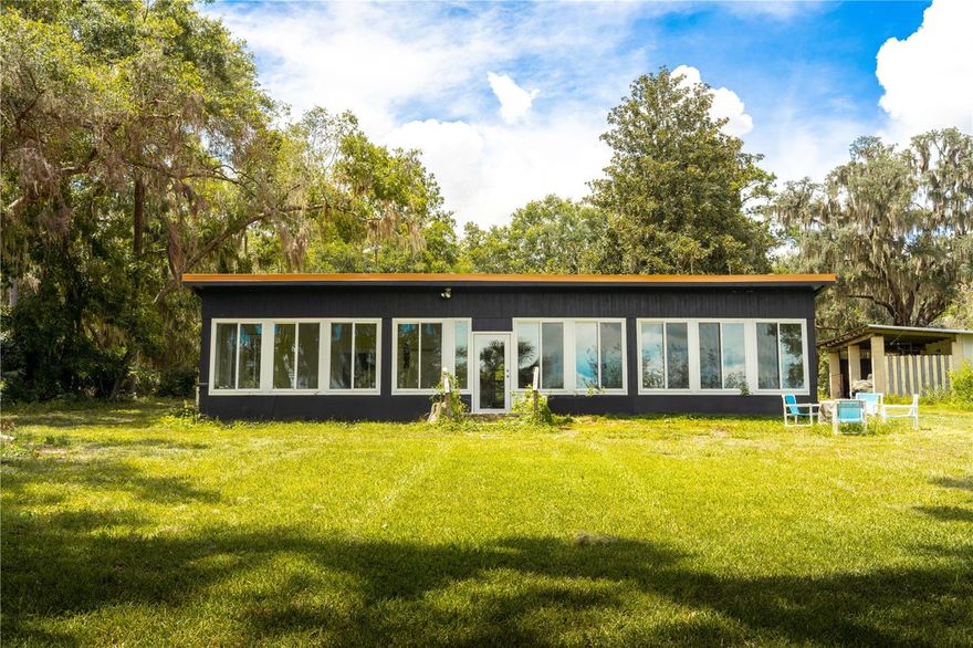 Welcome to your very own paradise on Little Lake Weir - a stunning 1 bedroom, 1 bathroom lake front home offering breathtaking views, private access, and the perfect blend of comfort and style. Whether you are seeking a year-round residence or a weekend escape, this property delivers a true waterfront lifestyle. Step inside to find luxury vinyl flooring, open concept living and panoramic windows that allows natural light and showcase the lake. Outside, enjoy time out on the dock where you can fish, relax, and watch the sunset. Unique to this property is an exclusive boat ramp where you can launch your boats and jet skis. House has new impact windows and door (2024) with lifetime warranty, new refaced composite deck, three mini splits, a new roof (2024), new breaker box, full RV/Camper hook up with 30 amp and water, two septic tanks that are active; Septic tank was cleaned out Feb 2025. Located just minutes from The Villages, you'll have easy access to dining, shopping, and outdoor recreation - all while feeling a world away. Don't miss your chance to own this slice of lakeside paradise. Schedule your private tour today!