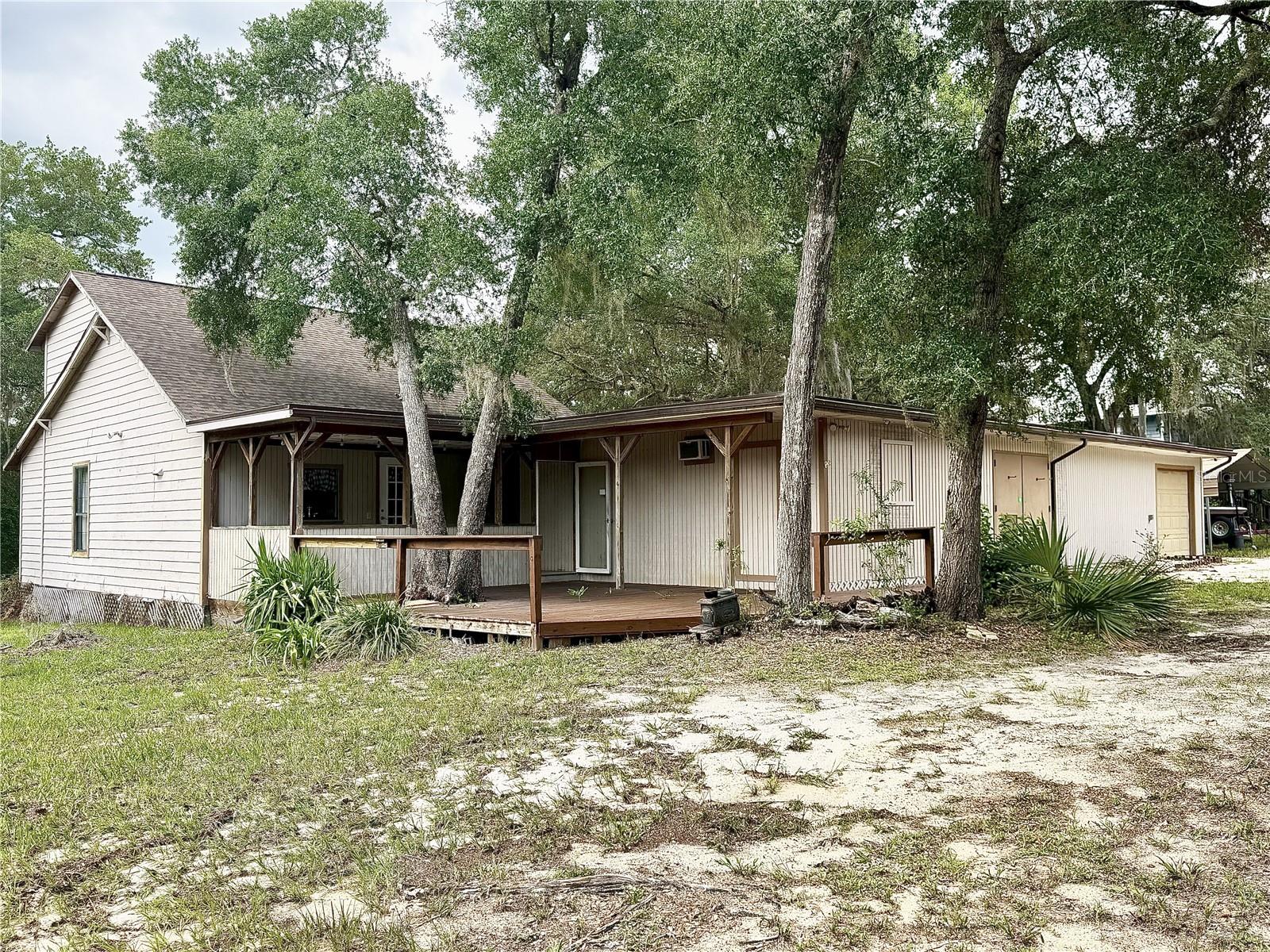 This move-in ready 3-bedroom, 2.5-bathroom home is tucked away in a peaceful area of the Ocala National Forest A one-car garage adds convenience and storage. This home is perfect for those who love the outdoors or simply want a break from the hustle and bustle of city life. Enjoy the serene surroundings from your wood front and back porches, ideal for relaxing mornings or quiet evenings. The primary bedroom is conveniently located on the first floor, while the two additional bedrooms and a full bathroom are upstairs, offering a flexible and functional layout. you’ll also find two bonus rooms perfect for a home office, gym, or guest space. The kitchen features ample cabinetry and a floating island, making it both stylish and practical. Whether you're looking for a full-time residence or a weekend getaway, this property is a rare find in a serene natural setting with easy access to fishing, hunting, and more. Bring your toys and four-wheelers—there’s plenty of space to roam and explore! Whether you're looking for a full-time residence or a weekend getaway, this property offers privacy, freedom, and access to all the outdoor adventure the Ocala National Forest has to offer.