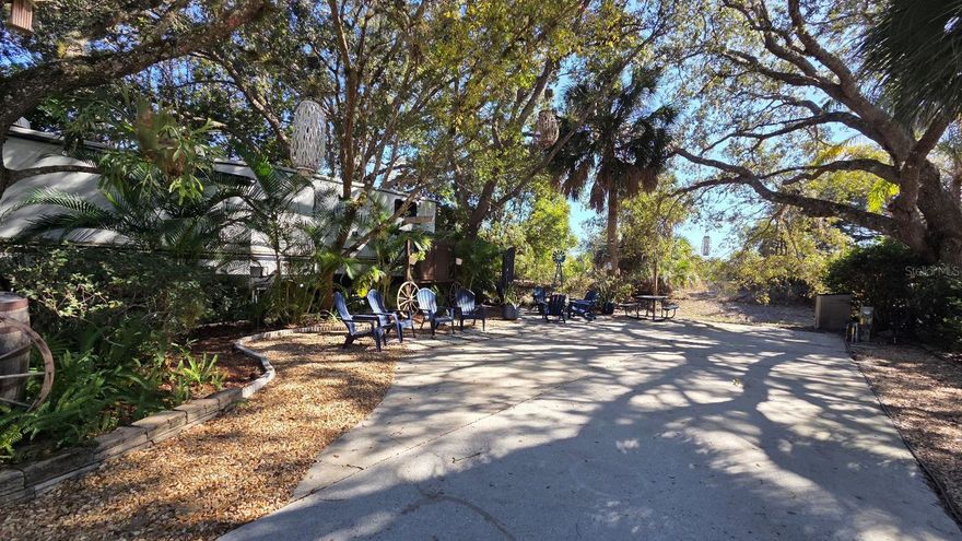 Looking for a LUXURY RV Lot to BUY in FLORIDA?  Experience the ultimate Florida "Glamping" lifestyle at Lot 174 in the highly sought-after River Ranch RV Resort. Tucked under a stunning canopy of mature oaks, this premium deeded lot offers rare privacy with no rear neighbors—a true sanctuary for your motorhome or fifth wheel. This turnkey property is fully landscaped and features an expanded paver pad, dedicated golf cart parking, and a custom fire pit area perfect for evening gatherings. Move-in ready and fully furnished, the lot includes multiple seating zones and a charming porch swing to enjoy the serene Central Florida breeze.  Beyond your private retreat, you are part of the world-famous Westgate River Ranch community.  Enjoy a front-row seat to the Saturday Night Rodeo, the Saloon with live entertainment, a brand-new water park, airboat rides, and an adventure park. With no RV restrictions and rental-friendly policies, Lot 174 is an ideal personal getaway or a high-performing investment property.  Don’t just visit—own a piece of the Cowboy Capital of Florida!