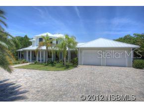 5 bed 5 bath gated riverfront estate seems park-like with over 1 acre of manicured tropical landscaping & 150ft of direct river frontage with seawall; truly 1 of a kind. Upon entering the home you are greeted by the impressive grand staircase, and the custom paddle ceiling fan above; both are centerpieces in their own right. Hardwood floors lead past the formal dining room, into an open floor plan family room & kitchen. The main living room & casual dining area is open and spacious & include marble gas fireplace, built-in entertainment center & adjacent alcove affords magnificent views of the intracoastal via 5 large bay windows. Gourmet kitchen is well designed in taste & efficiency; granite counter tops, triple-bowl sink & sleek stainless GE Monogram appliances. The kitchen connoisseur in your life will appreciate custom details like; double oven featuring GEs Advantium oven & large prep/bar island w/sink & ice fridge. Plentiful, spacious cabinets & custom walk-in pantry provide ample space for accessible storage. The large window floods the kitchen in natural light & also makes sunsets & sailboats the backdrop to your life. This home sits on the intracoastal & includes private boat dock & lift so life on the water has never been easier. Home also features; a free form pool & spa, beautifully pavered deck & driveway & wrap around porches. Large laundry room has custom cabinets, fold out ironing board, & hanging rack. Off the living room, the master suite features his & hers walk-in California closets, & private access to pool patio via French doors. Master bath is spa-like, complete with his & her sinks, oversized walk-in shower w/ triple shower heads & claw-foot bath tub. 3 guest bedrooms w/private baths & bonus room perfect for an office or 5th bedroom. 2 car attached garage plus 4 car detached perfect for a workshop or storing your toys.UNCOMPARABLE SUNSETS!!! ;Water: City