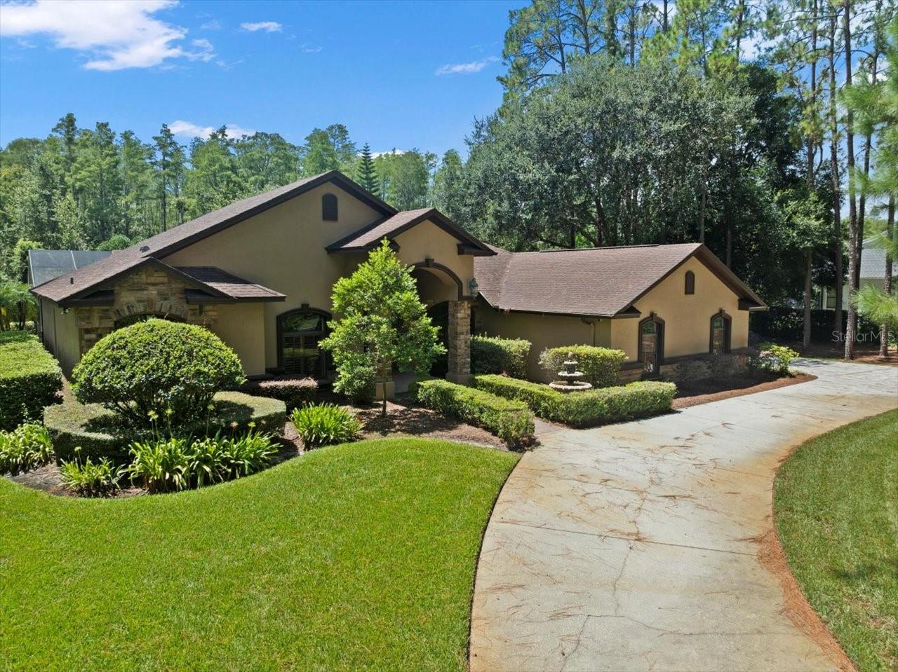 Beautiful Executive Home in Gated Lutz Community with Pool, Outdoor Kitchen & Putting Green! Nestled in an exclusive gated community, this stunning 4-bedroom, 3-bath executive home offers resort-style living at its finest. The desirable split-bedroom floor plan ensures privacy, with the luxurious Primary Suite and private office on one side of the home, and the guest bedrooms and bonus room on the other. The heart of the home is a gourmet kitchen with abundant counter space, quality cabinetry, and a spacious breakfast bar, flowing seamlessly into the open living and dining areas—perfect for both everyday living and elegant entertaining. The Primary Suite is a true retreat, featuring a spa-inspired bath with dual vanities, soaking tub, and walk-in shower, along with serene views of the pool and backyard. Step outside to your tropical paradise, where a sparkling pool with waterfall features, an outdoor kitchen, and a covered lanai invite year-round enjoyment. The lushly landscaped backyard also boasts a custom putting green, creating the ultimate space for both relaxation and play. With its prime location, exceptional amenities, and eleveted style, this home embodies the ultimate Florida lifestyle.