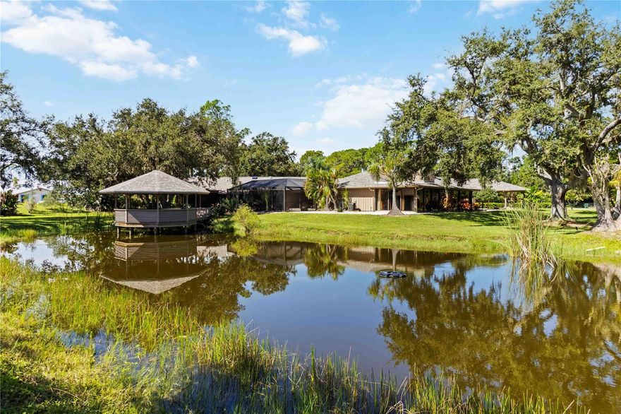 A truly rare opportunity to own a home on over 2 acres in Osprey, FL. Pine Ranch is a charming enclave of 36 properties with low HOA fees and sensible deed restrictions that offers room for your RV, boat, and space for your horses.

Conveniently positioned one mile East of US 41, within a mile of the Legacy Trail and the nationally-ranked Pine View School. Situated at the end of a cul-de-sac and bordering a protected preserve, this property offers privacy almost impossible to find West of I75 in Sarasota County. From nearly every window in the home, enjoy the views of the surrounding nature, a private fish-stocked pond, picturesque gazebo, and well-appointed pool area.

Improvements in 2025 include a new hot water heater, picture frame pool enclosure, and roof with transferable warranty. A thoughtfully designed addition expanded the original home adding a spacious primary suite featuring a vaulted ceiling, abundant natural light from multiple skylights, dual walk-in closets, a full ensuite bath, and direct access to an outdoor living space with wet bar and pool access. A beautiful library with custom wooden shelves and vaulted ceilings with a full pool bath too.

This home has a total of four bedrooms, two with ensuite bathrooms, all with sizable walk-in closets and four and a half baths. A formal living and dining room, eat in family room with a wood burning fireplace, wet bar and vaulted pecky cypress ceiling and walls, all add up to a great home to gather. The home also boasts a converted garage space which adds an additional air conditioned 500 square feet, plus a glass enclosed Florida room 555 square feet, these two areas add over 1,000 living square feet not included in the county records. Outside there is a large screened patio to truly enjoy the garden views, four car covered carport, free standing Barn/Workshop with garage door access and attached screened potting shed and a defunct pump house that could become a man cave or she shed!