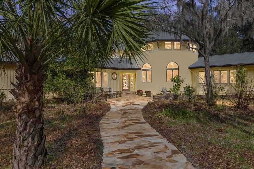 Simple, Serene, Breathtaking – 79-Acre Retreat with Endless Possibilities.   Escape to this idyllic farmstead, a haven shaded by centuries-old Live Oaks draped in Spanish moss, offering unmatched privacy and natural beauty. Located just 25 minutes from Gainesville and Ocala, this property combines tranquility with boundless opportunities for recreation, agriculture or expansion. Main Features: Architect-Designed Home: 2,400 sq ft, 3BR/3BA with vaulted ceilings, oak hardwood floors, a working wood-burning fireplace, 64 Anderson casement windows, and 1,100 sq ft of screened porches and decks. Guest Cottage: 1BR/1BA with heart-pine floors, charming front and back porches. Private 5-Acre Lake: stocked with bass and perch, perfect for fishing or relaxing with a kayak or canoe. 55,000-Gallon Saltwater Pool: Screened, solar-heated, and surrounded by natural beauty. Agricultural Potential: 20-acre pasture ideal for horses, 25 acres of mature pine forest, and a 1-acre fenced garden with a 9-ft deer fence, enclosed chicken run and sprinkler irrigation. Additional Amenities: Barns: 1,200-sq-ft enclosed barn with a concrete slab with power. Sustainability Features: Solar arrays for home and pool, buried power lines, two wells with pure water (one with a 5HP pump for farming or livestock), and a buried propane tank. Recreational Trails: Miles of hiking paths through conservation land and lush woods. Mature Landscaping: Peach, plum, avocado, citrus, and fig trees alongside chemical-free, organic grounds. Luxury Features: Tennessee flagstone walkways, custom heart-pine octagonal kitchen table, soaking tub in the master bath, large pantry, and breathtaking views of the pond from the living areas.  Opportunities for Expansion: The property is zoned for additional buildings/homes (4–6 possible), making it ideal for creating a family estate, farm stay rentals, a wedding venue or retreats. A tranquil setting adjacent to 4,000 acres of conservation land provides privacy and peace, with ample space for outdoor activities, small-scale agriculture, or equestrian pursuits. Whether you seek a private sanctuary, an agricultural lifestyle, or a business opportunity, this property delivers unparalleled versatility and charm. A Tranquil Paradise Awaiting You!