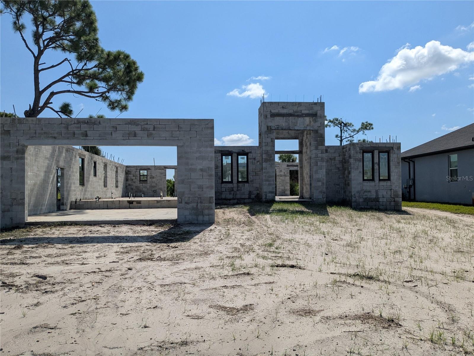 Your Dream Home is Waiting to Be Finished — Right on the Golf Course in Rotonda West! Here's your chance to bring your vision to life! This is not just a house — it’s a head start on something truly special. Located in one of the most sought-after neighborhoods in Rotonda West, this large 4-bedroom, 3-bathroom home is already underway and just waiting for the right buyer to complete the dream. The home is being sold as is, with permits already in place — no need to wait through months of paperwork. Designs and prints are ready and approved, and major groundwork is already done, including plumbing and drainage systems. With a 2-car garage, wide-open layout, and plenty of room to grow, this property has all the makings of a true showstopper. What really sets this home apart is the direct view of the golf course — enjoy peaceful mornings and golden sunsets right from your backyard. And when you’re ready to explore, Rotonda West has everything you need. Spend your days on one of the area's public golf courses, relax in nearby parks, enjoy local dining and shopping, or head just a short drive west to the Gulf beaches and Boca Grande, famous for its world-class tarpon fishing. With so much potential already in place, this property is a rare find. Why start from scratch when the hard part is already done? You get to choose the finishes, the flooring, the fixtures — make every detail your own. Whether you want modern touches or classic charm, the canvas is wide open and ready for your ideas. Don’t let this opportunity slip by. A partially-built luxury home with this location, approved plans, and existing permits doesn’t come around often. Call today to schedule your showing and make your offer. The future is bright — and it starts right here in Rotonda West.
