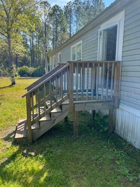 This spacious 4-bedroom, 2-bathroom manufactured home is situated on 1.14 acres of beautiful property in Flager Estates. Zoned as Open Rural, you will have ample space to park your work vehicles, RV’s, boats and toys.
The openness of this home creates a wonderful gathering place for family and friends. Adjacent to the large living room is a formal dining area that features a wood burning fireplace. Connected to both is a nice sized kitchen. The kitchen boasts updated white cabinetry, solid surface countertops, and stainless steel appliances by Whirlpool. Off of the kitchen is the laundry room which comes with an LG front load washer/dryer set and extra cabinet space, also with solid surface countertop.
This split floor plan home offers privacy for the oversized master bedroom. Its master bathroom features dual sinks and a walk-in shower.
The 3 additional bedrooms have immediate access to a large bathroom. One of the bedrooms is currently being used as storage room. Modern interior lighting and ceiling fans make this home move-in ready.
Recent updates include metal roof, A/C unit, and vinyl flooring in selected areas. With a little TLC it is a perfect property for those seeking a peaceful retreat with room to grow.