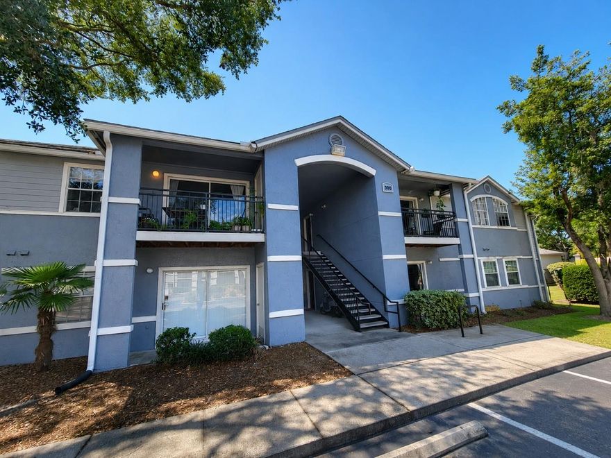 Move-In Ready & Furnished Ground-Floor 2 Bed/2 Bath Condo Near UF & Shands – On UF Bus Route! This updated condo features an upgraded kitchen, renovated bathroom vanities and countertops, newer A/C (2022), and newer flooring throughout the common areas. The open floor plan offers a spacious living/dining room combo with a breakfast bar, plus two large bedrooms, each with its own full bathroom. Enjoy relaxing on the covered porch with an exterior storage closet. Ideally located in one of the closest buildings to the community entrance and bus stop, providing quick and easy access to UF transportation. Ground-floor location offers added convenience with no stairs. Enjoy resort-style community amenities including a pool & spa, fitness center, basketball court, and tennis courts. Monthly HOA fee covers exterior insurance, exterior maintenance, internet, and cable TV. Conveniently located just minutes from UF Health Shands Hospital, the VA, the University of Florida, and shopping!