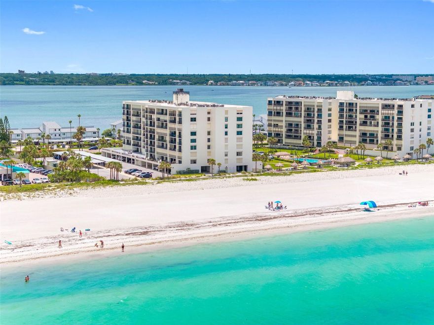 One or more photo(s) has been virtually staged. Panoramic ocean vistas and modern luxury blend seamlessly in this stunning beachfront property. Situated in a prime oceanfront location in the heart of Sand Key, this rarely available NW corner unit offers sweeping UNOBSTRUCTED views of the beach and Gulf that stretch all the way to Honeymoon Island. No expense was spared in this impeccable renovation. High-end touches include exquisite porcelain tile flooring that runs throughout, custom 5-inch base boards, new interior doors, ambient cove lighting, and upgraded floor to ceiling sliding doors that access a 23ft. balcony with incredible water views. All doors are protected by storm shutters. West facing windows provide direct views of the Gulf and abundant natural light. The designer Chef's kitchen is a masterpiece, perfectly configured for entertaining and maximum functionality. Custom features include shaker wood cabinetry with soft-close drawers, GORGEOUS Calcutta Cielo quartz countertop, custom ambient lighting, and top of the line stainless-steel Bosch appliances. There is even a West facing window with an ocean view for the chef! Both bedrooms are spacious with sliding doors that access the balcony and generous closet space that includes built-in organizers. The owner's retreat adds dual closets and ensuite bath with dual vanities. Luxurious spa-inspired baths feature lighted high-tech anti-fog mirrors, quartz countertops, and resort-style showers that include upgraded fixtures and dual shower heads. This property also comes with a premium under-building parking space and storage locker for your beach toys! South Beach I is a vibrant gated community that is perfectly positioned on one of the most pristine beaches that you will find anywhere. Experience unforgettable sunsets from the Tiki Huts and swim in the heated resort-style pool that overlooks the Gulf. Other amenities include a fitness room, pool baths, outdoor showers, onsite manager, and club room for social events. Close to everything including excellent restaurants, shops, entertainment, and the Jolley Trolley! Call now to schedule your tour. Virtual tours are also available.