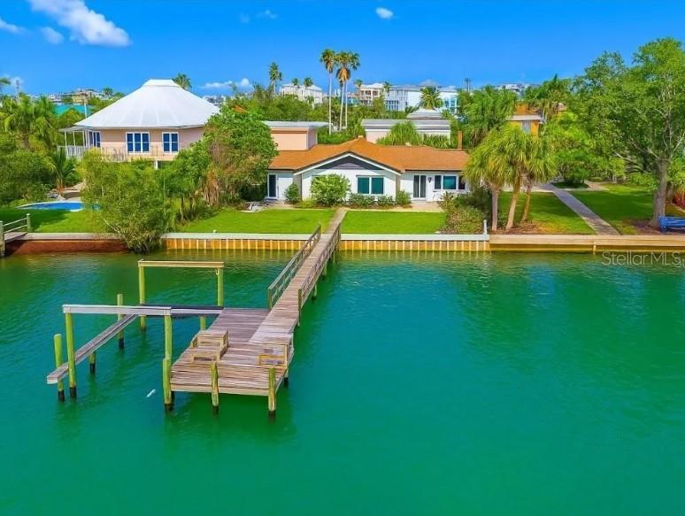 Waterfront opportunity on Boca Ciega Isle—rarely available and highly sought after. This solid block home offers deep water access with no bridges, a private dock with lift, and sunset views over the intracoastal. Walk or bike to the Gulf beaches, dine at top-tier coastal restaurants, and retreat to your private backyard oasis with pool and covered lanai. Spacious open layout, updated finishes, and floor-to-ceiling sliders invite natural light and seamless indoor-outdoor living. No HOA, no rental restrictions, no time to waste. Homes on this street seldom come to market—act now or miss your chance to own one of Saint Pete Beach’s most exclusive lifestyle addresses.
