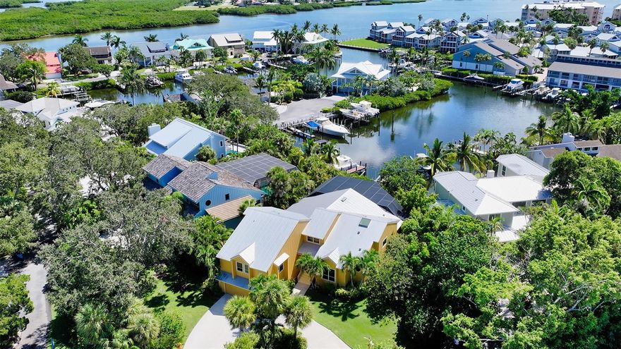 SIGNIFICANT PRICE IMPROVEMENT!!! Riegels Landing is locally known as the best neighborhood on Siesta key for boating and beach enthusiasts.  It is also known for its privacy and longtime residents, making it the ideal place to call home.  With properties rarely available in this highly sought after gated waterfront community, 5285 Riegels Harbor can now be yours.  Lush tropical foliage greets you as you enter through the private community gates.  Following the canopy streets, you arrive at your new waterfront home. The interior architectural design of the home focuses around soaring ceilings and large windows to allow an abundance of natural light, while showcasing the picturesque views of the harbor.  An open concept floor plan takes advantage of the 14 foot ceilings in the living room and chef’s kitchen, creating the perfect space for entertaining.  An island cooktop, double ovens, Sub-Zero refrigerator, dual sinks and ample cabinetry is all you can ask for in a kitchen. The oversized owner’s suite offers high ceilings, two walk-in closets, spacious bathroom, and a stunning office that overlooks the pool and Cove.  With 3 additional guest bedrooms on a separate floor and a total of 4.5 baths, privacy will never be an issue regardless of how many friends and family are visiting.  The outdoor living space is spectacular.  A summer kitchen and hot tub overlook the resort style oversized pool.  All of this is surrounded by lush tropical landscaping to maximize privacy, while not detracting from any views of the Cove.  Just outside the screened lanai, a second outdoor deck provides another location to relax and take in the peaceful setting of this spectacular location.  A private dock and lift afford you the opportunity to jump on your boat and be in the intracoastal waterway in minutes.  With no bridges and great water, this neighborhood truly earns its reputation as a boater’s paradise.  The oversized garage provides ample storage for all of your beach and water toys.  All of this, and only a short stroll or bike ride to white quartz sands of the world famous Siesta Key Beach, makes this an opportunity not to be missed.