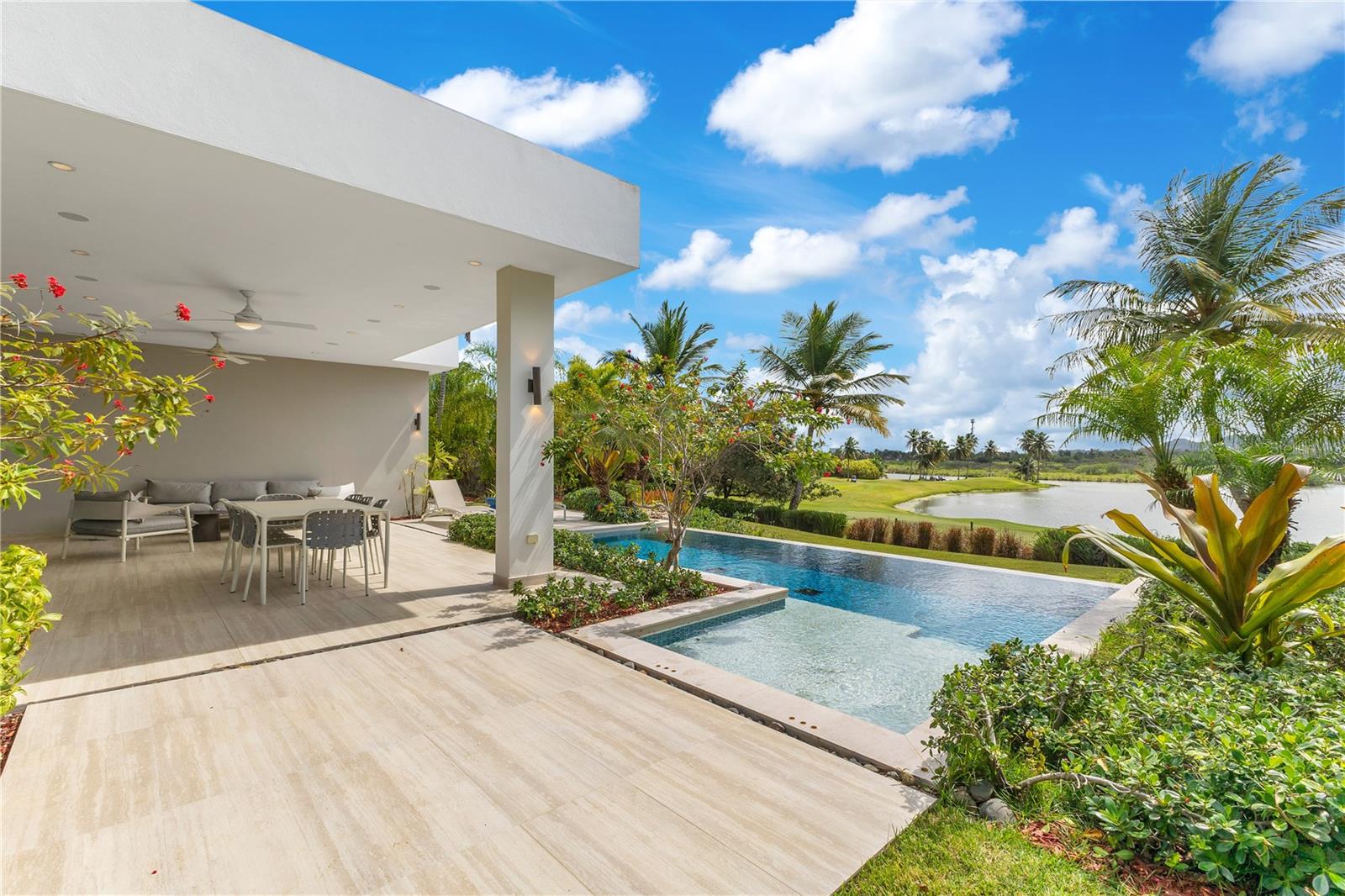 Come and experience living in Enclave, one of the most exclusive communities in the coveted Dorado Beach Resort, this stunning one-story residence offers an unparalleled blend of luxury, comfort, and breathtaking views. Spanning 3,453 sqft. of elegantly designed, conditioned living space on a 1,227 sqmt. lot, this 4-bedroom, 4-bath, and 2 half-bath home is a true sanctuary. All bedrooms have en-suite bathrooms great for privacy. The open-concept layout and soaring ceilings in the living area create a sense of spaciousness, enhanced by an abundance of natural light.
Enjoy serene lake and golf course views from the covered terrace and private pool—perfect for outdoor entertaining. The modern kitchen offers ample storage and panoramic views of the lake. The master suite is a tranquil retreat with direct backyard access, a spacious walk-in closet, and a spa-like master bath featuring dual showers, a soaking tub, and an outdoor shower for a resort-style experience.
Dorado Beach Resort and Club offers access to a wide range of world-class amenities, including the Sports Hub, Fitness & Wellness Center, Tennis Center, and a variety of restaurants. Enjoy the convenience of being close to everything you need for a comfortable and vibrant lifestyle.