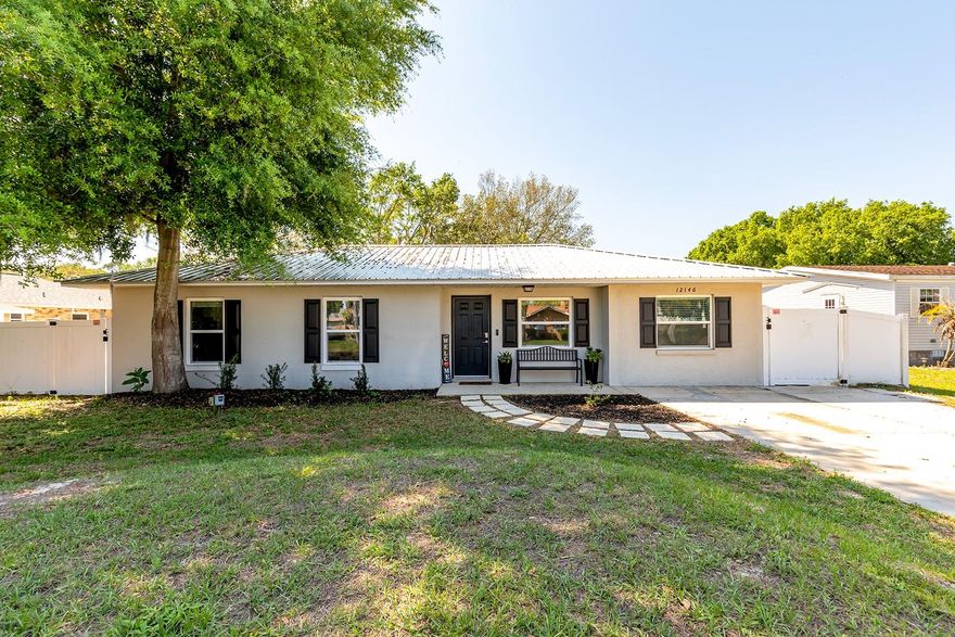 WOW! Don't miss this beautifully renovated home featuring 3 bedrooms, 2 baths in the main house plus an attached in-law suite with private entrance, complete with 1 bedroom/living area, 1 bath, and kitchenette—perfect for guests or multigenerational living. In USDA APPROVED ZONE FOR NO  DOWN PAYMENT!
This home has a 2022 metal roof, 2023 HVAC, and 2024 water heater, along with granite countertops, ample cabinetry, and stainless steel appliances. Enjoy life proof laminate and tile flooring throughout—NO carpet, plus updated bathrooms and modern lighting.
Step outside to a fenced backyard with a fire pit and storage shed, ideal for relaxing or entertaining. Located across from Lake Eustis, near the Dora Canal,  just minutes to Tavares Recreation Park and public boat ramps with access to the Harris Chain of Lakes. Conveniently close to shopping, dining, and everyday essentials, and zoned for the Tavares school district. NO HOA, NO CDD—a great opportunity!