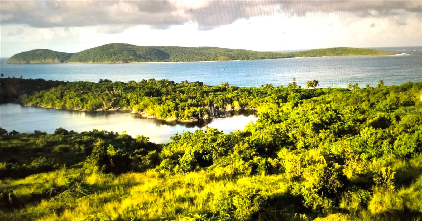 No shirt, no shoes... No problem! This large 1+ acre ocean-view lot is the most reasonable priced of similar lots in this location, just meters from spectacular Zoni Beach! (Ask the agent for recent comparisons.) Beautiful investment/residential land with panoramic sea views! Walk with your coffee for a dip each morning... or bring snorkel gear to explore the fabulous reefs at each end of the mile-long sandy beach. All year round, this beautiful lot is bathed in the Caribbean sun and refreshing trade winds. Investors and environmentalists alike will appreciate the promise of this property. Culebra's unique appeal as the last virgin “Spanish Virgin Island” adds additional appeal to this piece of paradise.
The lot features a flat or gentle slope, making it an ideal construction site for your dream home in the Caribbean. (Protection covenants require Caribbean hipped roof architecture). And don't worry too much about sea level rise. The 1+ level acre is located at an elevation between 75 and 100 feet above sea level. So sit back and relax while you watch the humpback whales and sailboats go by. The average daily temperature is 82 degrees, the nearby ocean is about 80 degrees, and the piña colada is best served frozen! (List Realtor is Owner.)
