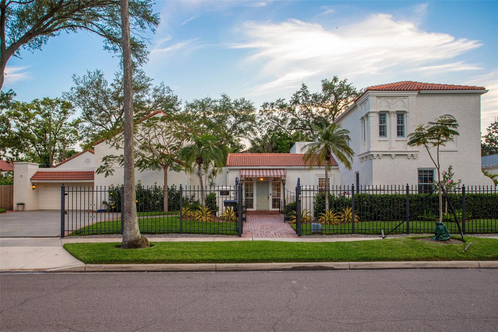 One or more photo(s) has been virtually staged. Luxury Living on Davis Islands: A Historic Mediterranean Masterpiece. Experience timeless elegance in this original 1920’s Mediterranean estate, a true icon of Davis Islands. Nestled on a spacious double lot, this estate is surrounded by lush, mature landscaping and features exceptional privacy fencing, a saltwater pool, and an electric wrought-iron gated entry for ultimate seclusion. This 6-bedroom, 5.5-bathroom home combines beauty and functionality, showcasing extraordinary custom features throughout. As you enter through the grand foyer, you're greeted with stunning flooring and an abundance of natural light. The first floor features separate living spaces, perfect for both formal and casual gatherings, along with a beautiful gas fireplace for cozy nights in. At the heart of the home, the gourmet kitchen is a chef’s dream come true. Featuring custom cabinetry, an expansive center island with Dolomite countertops, two sinks, floating shelves, designer tile backsplash, and unlacquered brass plumbing fixtures. Every detail has been carefully considered. State-of-the-art appliances include an iLVE 48" gas range, GE Monogram 48" refrigerator, Bosch dishwasher, Fisher & Paykel dishwasher drawer, microwave drawer, 174 bottle wine fridge, and back-up fridge. The adjacent butler's pantry is equipped with a wet bar, sink, ice maker, mini fridge, coffee station, and bar area for seamless entertaining. The first-floor primary suite is a true retreat, offering vaulted ceilings, two walk-in closets, and direct access to the tranquil backyard and pool area. The remodeled primary bathroom boasts a spa-like atmosphere with a large soaking tub, dual vanities, make-up station, water closet, and an expansive shower. Designed for both privacy and convenience, the home's split floorplan includes three interior staircases, leading to the additional upstairs bedrooms and en suites. The expansive backyard is nothing short of a tropical oasis, with mature landscaping, custom lighting, sound system, brick pavers, BBQ station, pool bath, and a heated saltwater pool - making it perfect for entertaining or simply relaxing in your own paradise. For added convenience, the home offers a large 2-car garage, plus an additional storage shed with shelving and lighting for all your tools and yard supplies. This newly renovated estate boasts numerous upgrades, including extensive structural updates, a new roof, gutters, drainage system, irrigation, pool heater and equipment, landscape lighting, Generac generator, HVAC systems, tankless water heaters, Sonos sound system (inside and out), high-speed fiber network, and a Waterdrop filtration system in the kitchen. Security system with cameras, designer lighting, and ceiling fans add the perfect finishing touches to this extraordinary home. Located in the highly rated school districts of Gorrie Elementary, Wilson Middle, and Plant High. This home is within walking distance of Davis Islands Village - offering charming shops, restaurants, and more. Residents also enjoy easy access to Marjory Park Marina, the historic Roy Jenkins pool, Sandra W. Freedman Tennis Complex, and plenty of parks and walking trails. The home is just minutes away from Hyde Park, Downtown Tampa, Water Street, Sparkman Wharf, and the Tampa Riverwalk.
This stunning estate epitomizes luxurious, sophisticated living with every modern convenience. Schedule your private showing today and prepare to be captivated by its charm and craftsmanship.