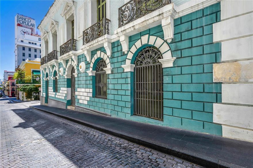 A landmark of architectural and historical significance, 152 Calle de Tetuan once housed the prestigious Spanish Bank, inaugurated in 1894 as a cornerstone of Puerto Rico’s financial past. Set along Tetuan Street, once the island’s bustling financial district, this property carries with it the legacy of culture and Old San Juan’s golden era. Today, the building stands as a rare opportunity to reimagine a piece of history. Spanning three expansive floors, the interiors feature an open floor plan with soaring 19-foot ceilings, inviting abundant natural light and endless design possibilities. The property also boasts a usable rooftop, which can be enclosed into a signature amenity space or transformed into an outdoor terrace with panoramic views of the bay and San Juan’s port to the south, an ideal setting for entertaining or enjoying the city’s maritime landscape. Whether envisioned as a grand private residence or a distinguished legacy estate, 152 Calle de Tetuan offers the perfect canvas. Its location at the heart of Old San Juan, coupled with its rich heritage and architectural character, makes it one of the most unique and versatile properties available in Puerto Rico’s historic capital.