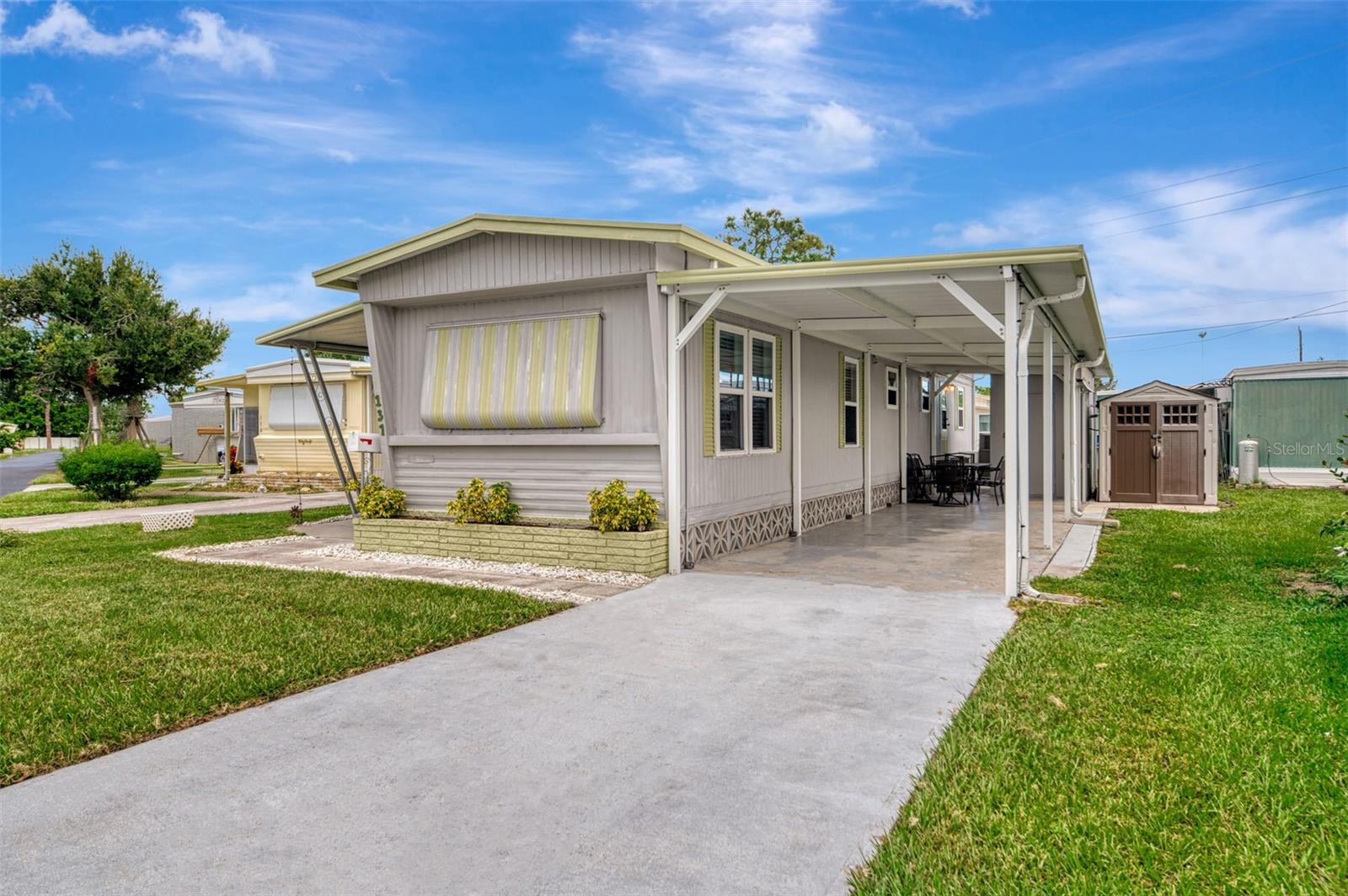 LOCATION! LOCATION! MOST AFFORDABLE 2 bedroom, 1 bath, 2 car carport, move-in ready, TURN-KEY MOBILE HOME, beautifully maintained & decorated, located in one of Englewood’s most sought-after friendly communities—Oak Grove Mobile Home and RV Park, A 55+ community. FULLY FURNISHED with upscale tropical décor and priced to sell, this charming home is the ideal mix of comfort, convenience, and Florida fun. just minutes to the Gulf Beaches! Step inside and be greeted by NEW ENERGY EFFICIENT WINDOWS, NEW CENTRAL A/C ($10,000 VALUE WITH TRANSFERABLE WARRANTY), and NEW LAMINATE FLOORING in the main living and dining areas, creating a fresh and inviting feel. The spacious FLORIDA ROOM (10x20) with vinyl windows is perfect for relaxing year-round, whether you're sipping coffee in the morning or enjoying a quiet evening indoors. The interior pops with TOMMY BAHAMA furniture and colors, giving the entire home a bright, beachy vibe. The kitchen is both stylish and functional, featuring white raised-panel cabinets, updated countertops, decorative lighting, and a roomy pantry. The Kitchen, Living room & Dining ROOM were updated with new insulation and mold resistant wall board. Whether you're making a quick snack or cooking a full meal, there’s ample counter space and storage to keep everything organized. The fully updated bathroom includes a QUARTZ DOUBLE SINK VANITY, tiled floors, built-in storage, and a full-size tub and shower combo—perfect for relaxing after a day at the beach. The master bedroom offers a peaceful escape with a large closet and plenty of storage, while the guest bedroom is just as comfortable, featuring WAINS-COATING ACCENTS and another large closet. Ceiling fans throughout the home keep things cool and breezy. Outside, enjoy a covered carport with LONG DRIVEWAY, FEMA-rated metal support beams—room enough for two cars or even a boat. including a LARGE METAL WORKSHOP SHED WITH ELECTRIC and full-size WASHER & DRYER, plus an additional 7x10 shed for even more storage. Oak Grove Park is packed with amenities—heated pool with new expanded pool deck, billiards, shuffleboard, bocce, putting green, croquet, library, picnic areas, and more—all for just $130/month, including lawn care! Just minutes from Manasota Beach, Englewood Beach, and the lively shops and restaurants of Old Dearborn Street and Venice Island. This home offers incredible value, unbeatable location, and a low-maintenance lifestyle. If you're ready to start living the Florida life, this gem in Oak Grove is waiting for you! Home is located on Rainbow Lane in the park, #137.