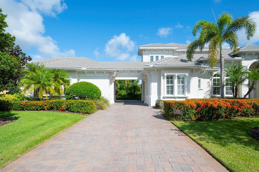 Positioned within The Lake Club neighborhood of Lakewood Ranch, this custom 5 bedroom  is surrounded by beauty and grace and  offers an unparalleled living experience. Pulling up to the house is a charming experience, enhanced by the detached carriage-style garage. Nestled on a spacious .54-acre lot, the property boasts privacy and stunning views of serene waters and lush, manicured landscaping. The open floor plan seamlessly connects the living spaces with outdoor spaces, creating an inviting atmosphere perfect for both relaxation and entertaining. Custom-designed shelving, fireplace and high-end finishes throughout further elevate the home's refined aesthetic.  The master suite serves as a private oasis, featuring a lavish ensuite bathroom and a custom-built closets. The gourmet kitchen is a chef's dream, equipped with state-of-the-art appliances,  elegant wood cabinetry, and a convenient walk-in pantry. Adjacent to the kitchen, the dining and living areas provide a seamless flow for hosting gatherings.  Outdoor living is equally impressive, with a resort-style pool and spa that beckon you to unwind. The expansive patio is complemented by an outdoor kitchen, ideal for al fresco dining and entertaining. The upstairs loft offers additional versatile living space, complete with a bedroom, bathroom, and a balcony overlooking the pool, perfect for use as a guest suite, home office, or creative studio. Located in the heart of Lakewood Ranch, The Lake Club is a private gated and vibrant community and offers a luxurious clubhouse, multiple swimming pools, fitness center, tennis and pickleball courts, scenic walking trails,  playground, basketball, Linear Park, and interlinking lakes for kayaking or fishing. Close to shopping, dining, A-rated schools, parks, and nearby beaches.The Lake Club community grants access to a host of world-class amenities. 8375 Catamaran Circle is ideally situated near upscale shopping, fine dining, and entertainment options, providing a perfect blend of tranquility and convenience. Don't miss your chance to experience the pinnacle of luxury living. Schedule your private tour today!