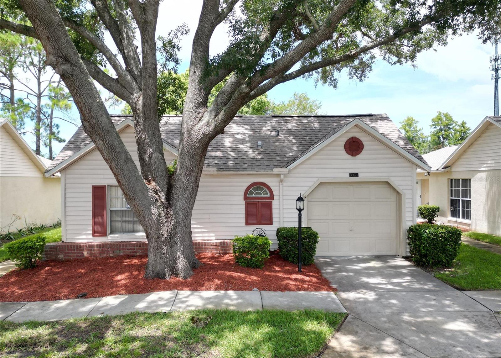 Enjoy Relaxed, Low-Maintenance Living in the Heart of Heritage Lake – A Premier 55+ Community! Welcome to this beautifully maintained 2-bedroom, 2-bathroom condo in the highly sought-after Heritage Lake neighborhood of New Port Richey. Designed for comfort, ease, and community living, this spacious home offers everything you need for an active-yet-relaxed lifestyle. Step inside through elegant double doors into an inviting open floor plan, featuring a bright and cheerful breakfast nook and updated laminate flooring throughout. The generous primary suite includes two walk-in closets, while the guest bedroom also offers a walk-in—perfect for visiting family or extra storage. A new roof was installed in 2025, and exterior painting and roof maintenance are handled by the HOA—giving you peace of mind and more time to enjoy life. Additional conveniences include a 1-car attached garage, in-home washer and dryer, and a large screened lanai—a perfect spot to enjoy your morning coffee or unwind in the evenings. As a resident of Heritage Lake, you'll have access to a vibrant community clubhouse with a pool, hot tub, tennis courts, and shuffleboard—all surrounded by beautifully manicured lawns and lush landscaping. Whether you’re looking to downsize or enjoy a simpler lifestyle in a welcoming 55+ environment, this home is move-in ready and waiting for you. Schedule your private showing today and discover the lifestyle you deserve at Heritage Lake!