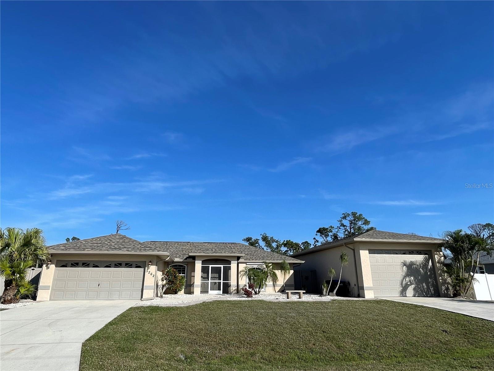 NEED EXTRA SPACE OR STORAGE. HOW ABOUT A SEPARATE GARAGE? This well maintained pool home sits on an oversized corner lot and includes a separate 25x50 garage. Bring the boats, travel trailers or antique Cars this Garage has Front and Rear 10' tall garage doors and includes 110 and 220 electric. The house features 3 bedroom, 3 baths, 2 car garage, pool and split bedroom floor plan. This home includes tile throughout, upgraded kitchen with tile backsplash, breakfast bar, nook and solid surface countertops. Great room with vaulted ceilings, Sliders to pool and patio area and separate dining room. The primary suite includes sliders to lanai, a walk-in closet, dual sinks, soaker tub and walk in shower. Guest bedrooms all have walk-in closets, bedroom 3 has an attached wheelchair accessible bathroom and the guest bath has a door to the pool area. Other features include: Large oversized corner lot with fenced yard, Whole house Generator, propane to run Stove, Water heater, pool heater and generator, epoxy garage floor in 2 car garage, mini split ac in 2 car garage w/ insulated garage door, spray foam insulation, new pool cage 2023, new roof 2023 (both house and garage), windows replaced in 2015, 2 sets of hurricane shutters. This is a great opportunity at a great price don't miss out. Make your appointment today.