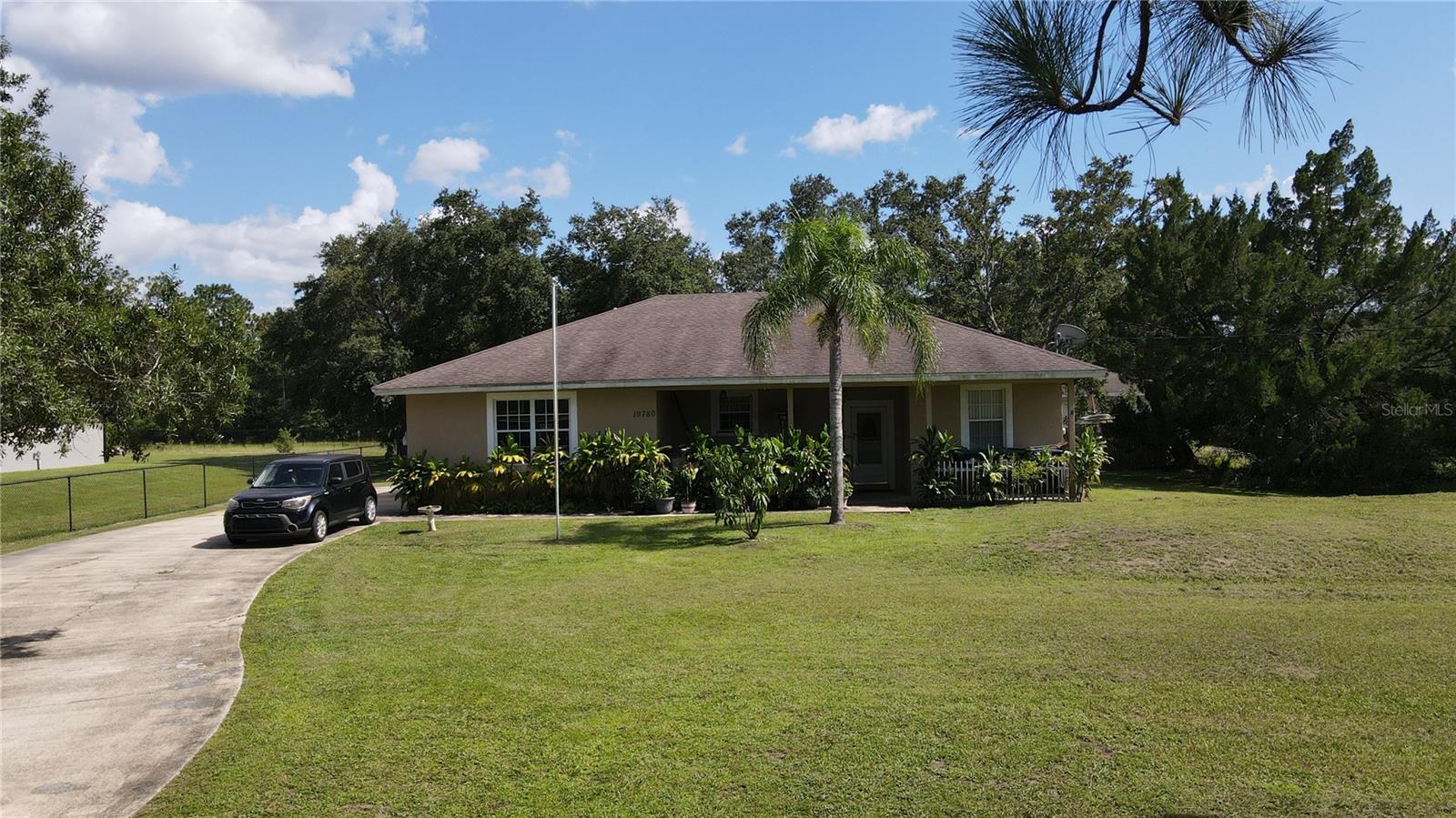 HIGHLY MOTIVATED SELLER!! NO FLOOD ZONE HIGH AND DRY!! Discover this spacious 4-bedroom, 3-bathroom home nestled on a 1.25-acre lot in a no-HOA community—offering room to grow and endless possibilities. Built in 2001, this property features a split-bedroom layout, a generous open-concept living area, and a screened-in patio perfect for relaxing or entertaining. The home includes a detached 2-car garage/workshop, in addition to the main garage, providing plenty of space for vehicles, tools, or hobby needs. The oversized lot offers privacy and room for future additions, gardening, RV/boat storage, or even a pool. While the property needs TLC, it's ideal for investors or buyers looking to personalize and add equity. With no HOA restrictions, you're free to bring your toys, pets, or projects to life without limitations. Located in a peaceful, rural setting with convenient access to major roadways, shopping, and dining, this is a unique opportunity to own a large slice of Florida with room to make it your own.