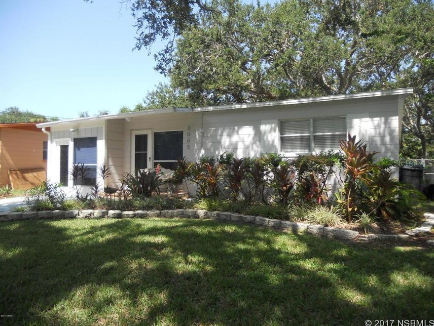 Enjoy the beach life in this charming renovated home in New Smyrna Beach blocks from the ocean. This 3/2 home features a master bathroom with a customized L-shape tiled shower area with three shower heads and bedroom barn style doors. There is a private office off the master bedroom with separate outside entrance. The renovated kitchen with bar style seating has new built in appliances. The kitchen is open to the living room, dining room and inside utility area. The spacious rear screened patio overlooks the large lot with lush greenery that surrounds this home convenient to all New Smyrna Beach has to offer. NEW A/C 2015, Roof replaced 2013. ;Water: City