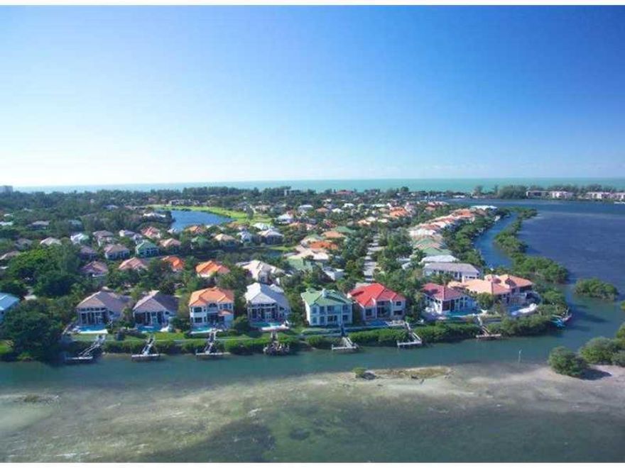 Bayfront masterpiece with breathtaking opulence, the best and the most private views! A home of this size and quality does not become available very often. Take in the beauty and phenomenal Bay views from this magnificent Queen's Harbour maintenance-free home. This residence, a Gardinera model, was the signature model for Queen's Harbour. Designed with endless Nancy Freedoff decorator touches throughout. Behind Harbourside gate of Longboat Key Club, this stunning residence features a grand entry with 20' ceilings & walls of glass, cook's gourmet kitchen with granite counters, custom wet bar & separate dining room. Generous rooms in this 5bdrm den/office plus bonus room. Master suite is on the main living level with views of the Bay & pool (uniquely designed with spa built into pool). Gas fireplace in living room and office plus a private dock with a boat lift. This home has hurricane shutters. This home is 12.3' above sea level per elevation certificate. Beach membership includes private beach on gulf with showers, grills, volleyball and more. Live minutes to a 45 hole golf course, 40 plus tennis courts, 2nd largest marina on the west coast, shopping, dining, near everything. NEW A/C handler and compressor for the master bedroom zone Feb 2013. New pool pump Jul 2013. Bay Isles Master Association is $1918 yearly. This home can also be purchased with furnishings currently inside for $2,450,000.