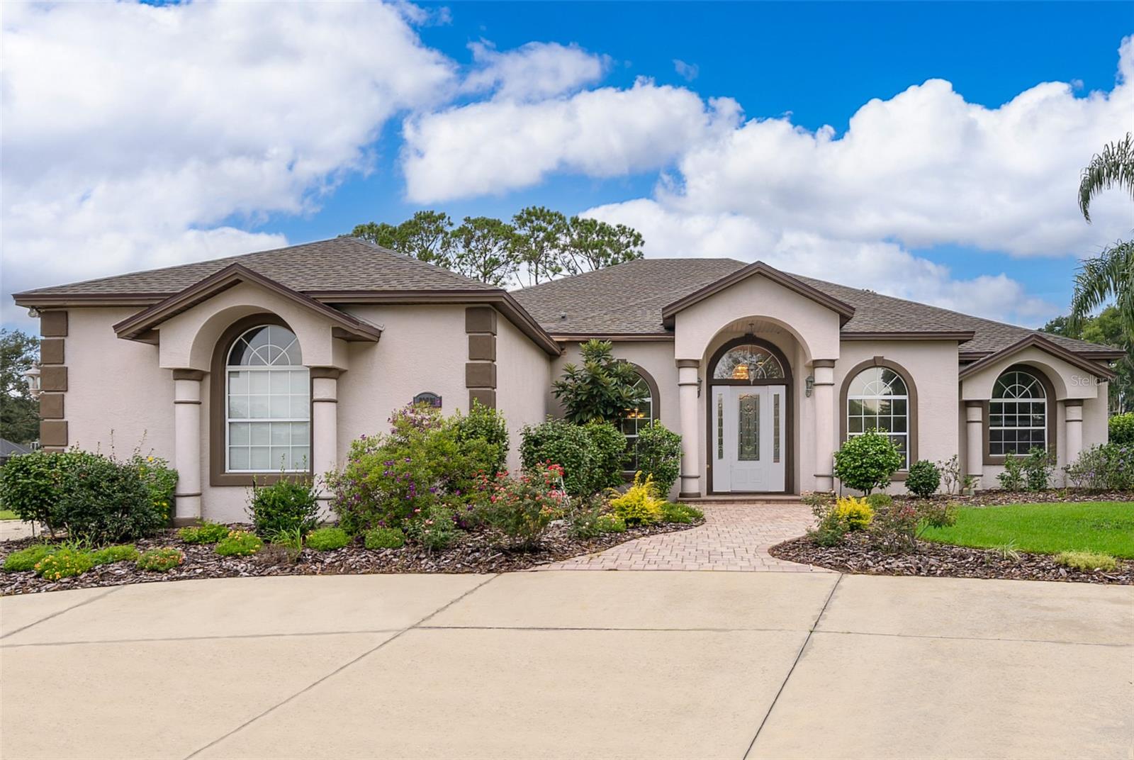 One or more photo(s) has been virtually staged. Beautifully UPDATED custom home on 2/3 acres in Harbor Hills Country Club near the main gate! Brand NEW ROOF, high efficiency HVAC and HOT WATER HEATER replaced in 2022. NEW ceramic tile floors, FRESH PAINT, NEW lighting/fans throughout. Rare dual driveways lead to a side-facing 3 car garage. Gourmet kitchen with black granite, gas range, beverage station, and center island. Split floorplan with office, formal dining, enclosed lanai with new split unit, and spacious master suite. Laundry room is conveniently located near garage. Enjoy golf course views and optional club amenities. Priced to sell!
