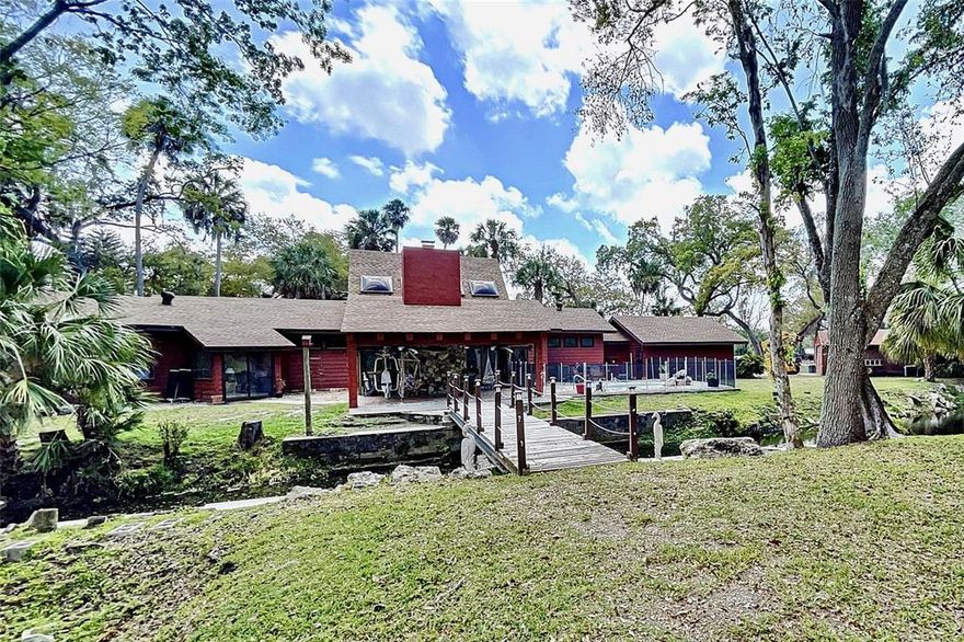 Two homes situated on over 16 park-like acres with a Spring Fed – 120 ft deep Lake (approx. 6 acres in diameter). This property is spectacular!!! The main home and guest/home #2 have the look and feel of a cozy cabin in the mountains. As soon as you walk in the main house thru the solid wood double front doors, you will fall in love with the Massive Great Room with its high vaulted ceilings made of Natural Pine, Tongue & Groove Wood and floor to ceiling stone, wood burning, fireplace, skylights and glass sliders leading to a covered back porch overlooking the most tranquil setting of a brook/stream and inground Plunge Pool with waterfall, LED lights and safety fence surrounding entire area. The Main house is 2674 sqft with 3 Bedrooms and 4 Baths, Kitchen boasts solid wood cabinets, red cedar countertops and bar/island. The oversized master bedroom has a vaulted ceiling, full bath with soaking tub and glass doors leading to a private screened porch. There are 2 a/c units, one unit is approx. 3 years old, the other is approx. 1 month old, the other is approx. 1 year old. New roof. The second house has the same mountain cabin feel with 1818 sqft of living space, 3 bedroom 2 baths, vaulted ceilings and indoor laundry room. The a/c unit is approx. 4 years old. There is also a garage and carport separate from the homes. Privacy galore but close to stores, restaurants, and a short drive to Florida’s beaches. True Paradise!