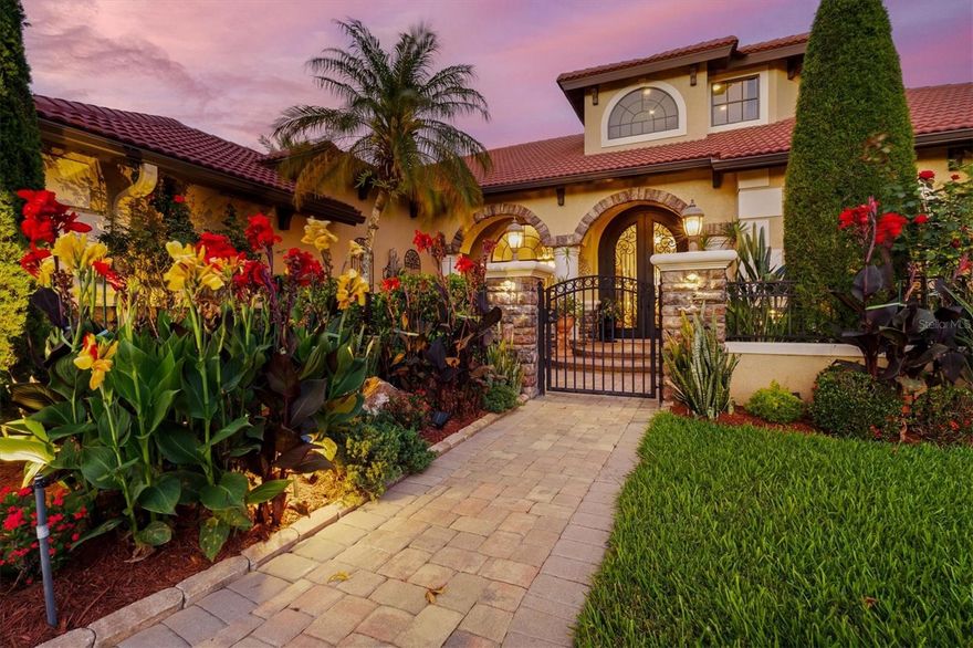 Blending sophisticated design with the feel of a luxury retreat, this stunning 4-bedroom, 4-bath spacious executive home is designed to make you feel like you’re in a secluded tropical escape in the sought-after gated community of Serenoa. The Serenoa community offers 1/2 acre to 1+ acre lots with tree lined streets, lakes & a golf course (golf course membership is optional).

From the moment you arrive, the picture-perfect curb appeal makes a lasting impression. A beautifully paved courtyard welcomes you with a soothing fountain, vibrant tropical vegetation, and a serene atmosphere that immediately sets this residence apart. Inside, the front foyer showcases decorative tile inlays, elegant archways, chandelier lighting & a spiral staircase leading to the upstairs loft. 

Thoughtfully designed with both sophistication and functionality in mind, the expansive layout includes a private office with custom built-in shelving and storage, a formal sitting room, formal dining room, gym, and a spacious den, offering flexibility for work, relaxation, and entertaining. The split-bedroom floor plan provides privacy, while open-concept living spaces create an inviting flow throughout the home. Rich tile flooring spans the main living areas, complemented by plush carpeting in the bedrooms for added comfort. 

At the heart of the home is the showstopping kitchen, designed to bring everyone together. An L-shaped center island with bar-top seating and stained-glass pendant lighting anchors the space, while dark wood cabinetry, stainless steel appliances, a dry bar, and a breakfast nook overlooking the pool create a space that is both functional & beautiful. 

The sophisticated family room offers an inviting yet refined ambiance with a coffered ceiling, fireplace, custom built-ins, and unique architectural details, all enhanced by sliding glass doors that seamlessly connect indoor and outdoor living spaces. 

The luxurious primary suite feels like a private retreat with direct access to the lanai and pool, a coffered ceiling, charming window seat, and a connected gym space for ultimate convenience. The spa-inspired en suite bathroom features dual vanities, a soaking tub, separate walk-in shower, and a spacious walk-in closet. 

Additional guest accommodations are generously sized and thoughtfully positioned, while the den with nearby wet bar and lanai access creates the perfect secondary entertaining space. Upstairs, the loft and additional bathroom offer endless possibilities for hosting guests, game nights, or a private lounge area, complete with a balcony overlooking the sparkling pool below. 

Outdoor living reaches another level with the massive screen-enclosed lanai designed to capture the beauty of the surrounding water and golf course views. Multiple sliding glass doors throughout the home create effortless access to this spectacular outdoor retreat featuring a resort-style pool and spa with a cascading waterfall, expansive covered lounging areas, and a fully equipped outdoor kitchen and bar with a grill, range hood, sink, refrigerator, and cabinet storage. 

Elegant, inviting, and truly one of a kind, this remarkable residence embodies Florida living at its finest. Every space is thoughtfully designed to elevate both everyday living and unforgettable entertaining in a setting that feels like a permanent escape. A home of this caliber is best experienced in person. Come see it for yourself and discover the lifestyle that awaits!