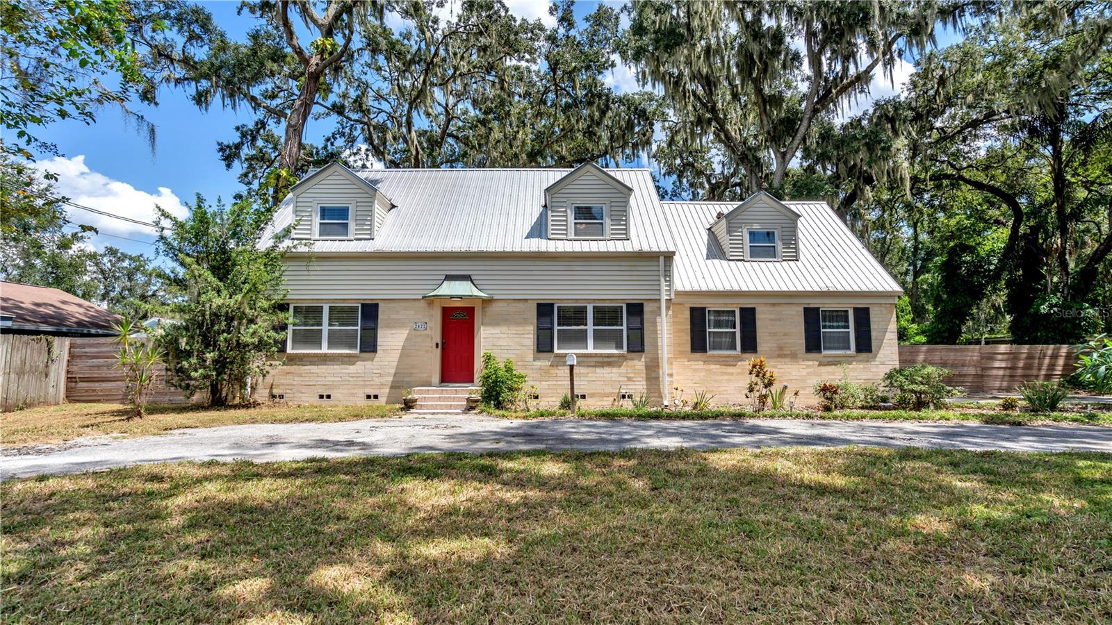 New Listing! Have you desired to live in the Lake Hollingsworth area? Now is your opportunity! Check out this ADORABLE two story move in ready 3 bedroom, 2.5 bath, 1957 Historic home! You will LOVE the charming details, refinished hardwood floors, trim work, built-ins, and the entire home is light and bright with lots of windows. The charm of history meets modern convenience. The traditional style floor plan includes living room, formal dining room, kitchen, and half bathroom downstairs. Upstairs there are 3 bedrooms and 2 bathrooms. The updated eat-in kitchen features stainless steel appliances, corian countertops, wood floors, and a walk-in pantry storage under the stairs. The adjacent living room is spacious and features beautiful polished terrazzo floors, lots of windows, and sliding doors out to the deck. The formal dining room is in the front of the home and can accomodate a large table for entertaining. The master bedroom suite has 4 windows with beautiful views, 2 closets, and a private bathroom. This home was originally built as a 4 bedroom home. The third bedroom is giant and includes two walk-in closets. This expansive space used to be two separate bedrooms, and at some point in the history of the home a prior owner took down the wall. If you and your family needed/wanted a 4th bedroom a wall could be put back up in the future. The oversized fenced in backyard is your own personal oasis, perfect for entertaining, or relaxing at the end of a long day. You will appreciate the mature landscaping, open deck, a detached shed, 2 car garage, and extra large circle driveway in the front. The many recent updates and upgrades over the last few years include: professionally refinished hardwood floors and terrazzo, vinyl windows, new sliding door, metal roof, interior paint, stainless steel appliances, new wood fences, and much more. Enjoy the convenience that this home brings. You can't beat the location! Enjoy walking, jogging, or biking from your new home around Lake Hollingsworth's 2.7 mile path. Your dream of living in a charming historic home is about to come true! Call today for your private tour!