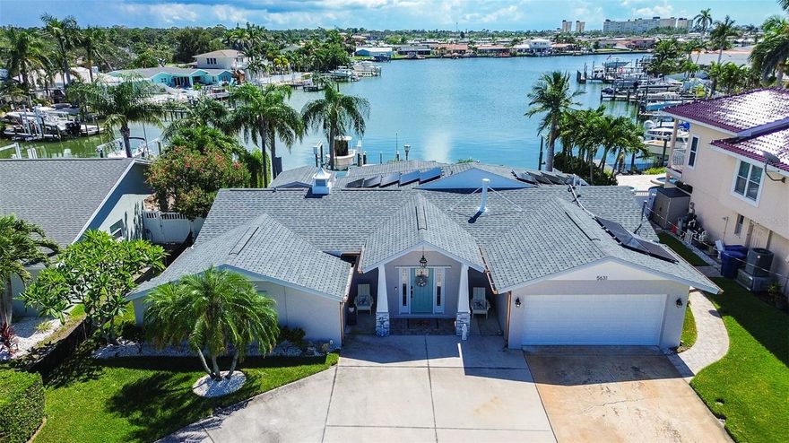 DON’T MISS THIS BEAUTIFULLY UPDATED WATERFRONT HOME! Located in a desirable Pinellas County neighborhood, this property offers direct water access and has been completely remodeled inside and out in (2024), with Arguably one of the BEST backyard Views on the street! Step inside to find all-new tile flooring, fresh drywall, a brand-new kitchen with new appliances, fully renovated bathrooms, and fresh paint throughout. This home comes equipped running on natural gas and includes a fireplace (gas). Other major (2024) upgrades include a new A/C system with ductwork, new garage door, new pool filter with heated system, Tankless water heater, and a Whole-house (gas) generator powerful enough to run the entire home, including the A/C. The exterior was also freshly painted in (2025). For added value and peace of mind, the roof and solar were replaced/Installed in (2018) SOLAR TO BE PAID OFF AT CLOSING, Hurricane-rated windows and sliders were installed in (2018), and the home is equipped with a NEWER dock and a (12,000) lb boat lift for easy access to the water. This property did experience minor flooding during Hurricane Helene in 2024 however, the neighborhood had never flooded prior to that event. Since then, the home has been fully restored with high-quality updates, making it truly MOVE-IN-READY. Schedule a showing to view today!