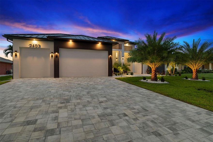 One or more photo(s) has been virtually staged. The Epitome of Luxury Living in Cape Coral, Florida! A Mesmerizing NEW CONSTRUCTION Home with GULF Access and Incredible Attention to Detail, overlooking the 140+ ft wide BONEFISH Canal! QUICK GULF ACCESS by Boat! Featuring 3 Bedrooms +Den, 3 Full Bathrooms, and a 3 Car-Garage (9 Ft Height) with a large driveway with sealed pavers, and 2200 sq. ft. of living space and a SentriGard Metal Roof. Beautiful landscaping with palms galore! Cool off on the large enclosed lanai with a Heated/Saltwater POOL and SPA with multi-colored pool lights and SmartApp controls. There’s an outdoor grill station with a bar seating area along with a built-in TV (65”) console station overlooking a large body of water, a spectacular sight! 

The entire length of the back of the house is enclosed with a picture screen enclosure, giving you lots of space to entertain or layout and soak in the Florida sunshine. There’s a 10ft SEAWALL and the entire property has been ELEVATED for additional peace of mind. Pleasant views of the Bonefish Canal right from your backyard along with some incredible fishing! Lots of natural light shines through the 16ft wide impact glass sliders that lead into the living area, with natural light beaming off the beautiful porcelain tile flooring spread across all rooms throughout the home. The living room features 12ft coffered ceilings, a CUSTOM-BUILT TV entertainment console with an electric fireplace and 85” TV. The kitchen features quartz countertops, Stainless Steel Appliances, and sleek two-tone minimalistic kitchen cabinets giving the space a streamlined look along with plenty of storage space. A large wrap around waterfall island with extra seating overlooking the dining and living area. The dining room has an elegant chandelier along with a coffee/wine station and extra cabinet space along with a built-in cooler. The laundry room is just off the side of the kitchen and has plenty of storage space along with a washer and dryer and an extra refrigerator. 

The primary bedroom is facing the water, has separate sliding doors leading to the pool, two LARGE walk-in closets with built-in shelving and modern finishes. The primary bathroom features double sinks, smart toilets, a large tub with an elegant chandelier and a mesmerizing backdrop. A large shower space with multiple showers heads and real unique tile covering majority of the bathroom walls. Within walking distance to the upcoming Seven Island Project and many other local amenities. This one is a must-see! Schedule a tour today, this home is 100% Completed! City Water and Sewer, All Assessments are Paid!