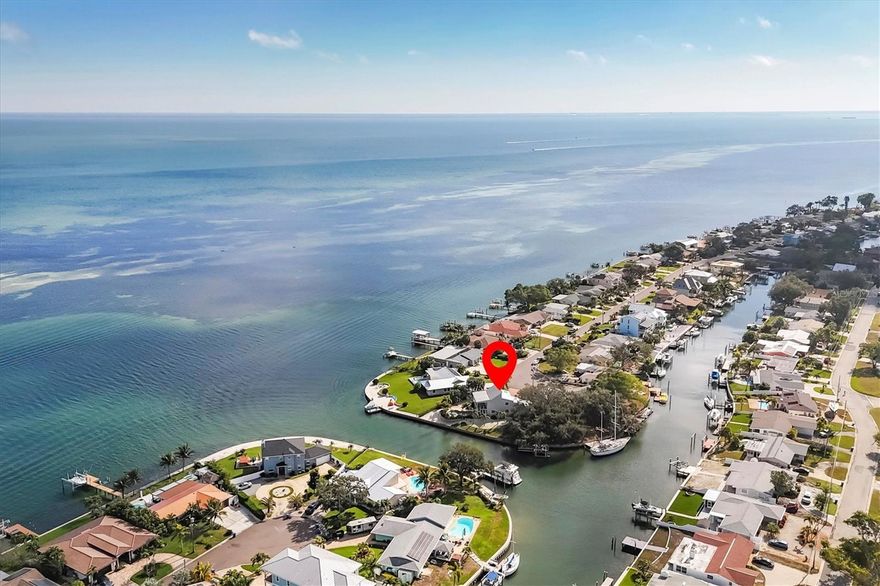 One or more photo(s) has been virtually staged. Beautiful waterfront home with amazing views of Tampa Bay! Just over 1/3 acre and 180ft of seawall, this property offers many ways to enjoy outdoor living. A boaters dream! Rear balcony and patio overlook heated saltwater pool, spa with breath taking views. Relax in the shade from the large oaks near the dock and boatlift while catching a glimpse of a dolphin or manatee. While inside you will enjoy water views from most rooms. Spacious great room, dining, kitchen and half bath are on the second floor with 3 bedrooms and two baths tucked away downstairs for privacy. Convenient St. Pete location. Just a short drive to downtown St. Pete. Call for your private viewing today!