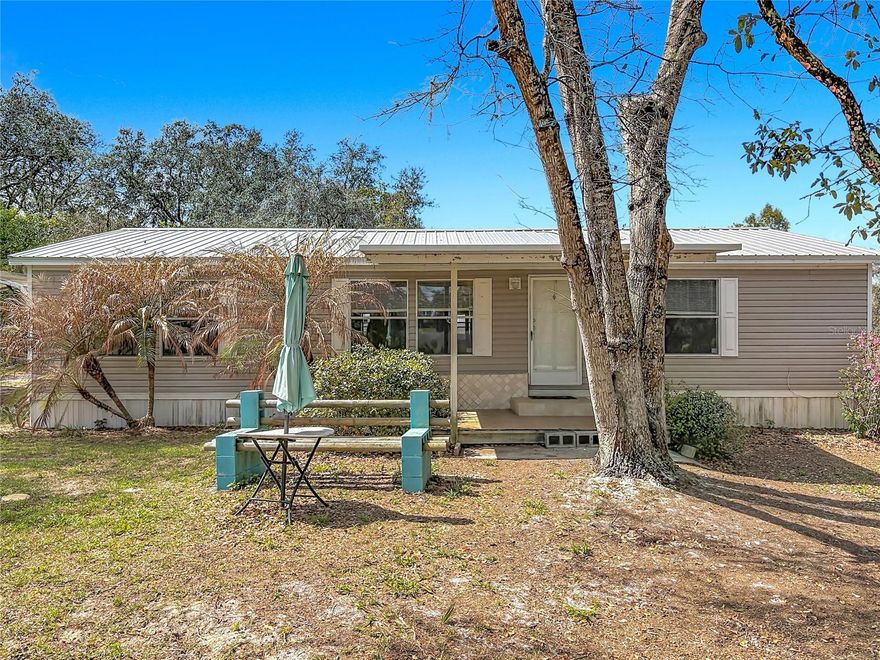 RARE FIND! Looking for Space, Privacy, and the ULTIMATE Workshop set-up? This 1.1 acre of private property offers the perfect combination of country living and functional workspace. The standout feature is the 30 X 50 metal outbuilding equipped with three roll-up garage doors, a car lift, an Ingersoll Rand air compressor, and dedicated workshop area making it ideal for mechanics, car enthusiasts, hobbyists, or small business owners.  Door sizes include two 10 x 9 doors and one 9 x 7 door. An adjacent 20 x 21 carport provides additional covered parking for workspace. Access is convenient from State Rd 44 through a 100 ft. vinyl fenced gate (2023) making it easy to bring in trailers, equipment, boats, and all recreational toys, or from Pond View at the rear of the property for everyday comings and goings. Recent upgrades add peace of mind including a metal roof installed (2022,) a Goodman A/C (2023,) and the septic was serviced 4/2025. The home is on a private well. NO HOA! Inside you will find 3 bedrooms, 2 bathrooms, a large eat-in kitchen with breakfast bar, a good-sized great room with large window to bring in natural light, and an enclosed rear porch that is perfect for enjoying some relaxation time. There is an inside laundry room with full size washer and dryer. The property includes two storage sheds and an additional double wide carport.  Enjoy the quiet country feel where you might even hear a rooster in the distance, while still being conveniently located near town. With plenty of open land for pets, gardening, or outdoor activities, this property offers endless possibilities for those seeking space and privacy. Definitely a MUST SEE!