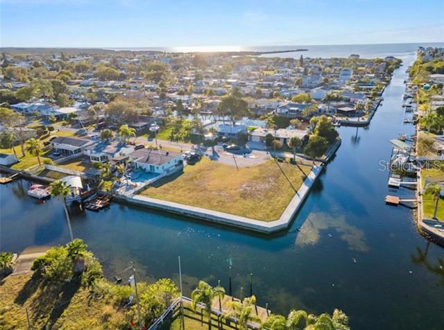 Want to BUILD on the Gulf Coast? This lot checks ALL THE BOXES! Large, double corner lot (10,890 s.f.) with 235 linear Feet of newer Sea Wall along TWO canals. Wide channel with direct access to open water (no bridges). Electric and City Water/Sewer services at the street. Cleared and level with engineering reports available. Did we mention NO HOA fees (nor any CDD fees). All you need is your plan and builder to get started! Live your best life here on the water. Hudson is a quiet community, and this lot is near all the beach hotspots. Enjoy sunsets every night or jump in your boat for a fabulous day on the water! Fish from your own backyard from the sea wall with 6 foot wide cap, installed 2021. Wildlife abounds with various sea and coastal birds, manatees in the winter, and of course, the thrill of watching dolphins from your own piece of paradise. Convenient access to commuter routes via US-19. Direct access to Gulf with deep water and no bridges, newer seawall, previous soil reports available. Don't wait, this lot won't be available for long.