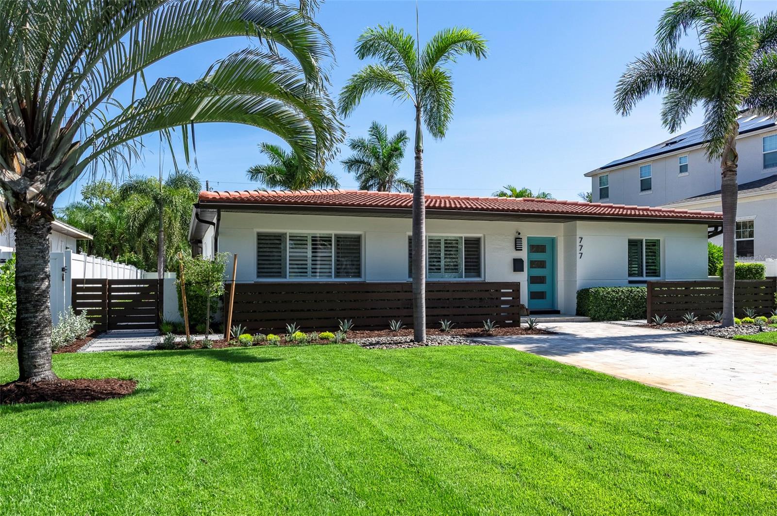One or more photo(s) has been virtually staged. Superior condition 3BR/2BA home with a resort style pool and backyard located in the Snell Shores neighborhood. This beautiful home has been tastefully updated with new 8”x48” Daltile flooring throughout, white shaker kitchen cabinets with Calacatta Abezzo quartz countertops, Samsung appliances, solid core doors, and fresh, neutral paint. In addition, a 30-year tile roof was just installed in January 2025. All rooms have plantation shutters and crown molding. The primary suite is spacious with an en-suite bath, enclosed glass shower, and new vanity. There is ample living space with a front living room and back family room overlooking the impeccably landscaped backyard, which also includes travertine patio pavers and artificial turf for easy maintenance. The laundry room area is air conditioned (HVAC replaced in July 2023) with a utility tub and plenty of room for a folding table, craft or wrapping station, and ample overhead storage. There is also an 8' x 12' lockable shed in the backyard for additional storage. The yard is enclosed with white vinyl fencing and a double gate for easy access to the alley. The pool is heated by roof mounted solar panels for year-round use, and this home is one of a few with a front driveway that comfortably accommodates 4 cars. Conveniently located approximately 3 miles from downtown St. Pete and within walking distance of the Crisp Park boat ramp.