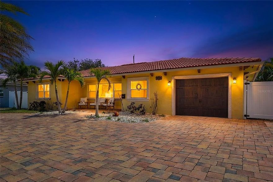 If you love to entertain, this home is about to steal your heart. Welcome to 3890 Benson Avenue North in St. Petersburg—a beautifully updated 2-bedroom, 2-bath residence designed for effortless indoor-outdoor living and unforgettable gatherings. 

From the moment you arrive, you’ll appreciate the stunning semi-circular brick paver driveway, offering exceptional curb appeal and ample parking for guests—setting the tone for the entertainer-friendly experience that awaits.

The true showstopper lies beyond the doors—an incredible backyard retreat built for hosting on any scale. Your private outdoor paradise features a sparkling saltwater pool surrounded by elegant travertine decking, creating a resort-style ambiance right at home. Two pergolas anchor each end of the pool, offering shaded lounge spaces perfect for relaxing with guests or enjoying a quiet evening cocktail. The fully equipped outdoor kitchen makes grilling and serving a breeze, while the expansive entertainment area provides plenty of room for dining, lounging, and celebrating.

Take your hosting to the next level with a pre-hung outdoor TV, subwoofer, and integrated speaker system—all easily controlled through the HEOS app—so you can set the perfect playlist or game-day atmosphere in seconds. Thoughtful outdoor lighting enhances the mood after sunset, while vinyl fencing ensures privacy for you and your guests.

Inside, the home continues to impress with a renovated kitchen featuring custom solid wood cabinetry, granite countertops, stainless steel appliances including a Bosch dishwasher (2022), new microwave (2024), and LG refrigerator, plus bar seating ideal for casual gatherings. Tile flooring runs throughout—no carpet—while the updated bathroom offers marble walls and a travertine walk-in shower for a touch of luxury.

Major upgrades provide peace of mind, including a new Daikin high-efficiency 3-ton AC system with HEPA filtration (2024), upgraded 200-amp electrical panel (2024), and a new garage door (2022). Additional features include double-pane insulated windows and sliders, a concrete tile roof, newer ceiling fans, Levolor blinds, outdoor security cameras, and a Ring doorbell, along with a transferable termite bond. This home is located in a non-evacuation zone, requires no flood insurance, and has no HOA—offering both peace of mind and financial savings.
Located 2 blocks from the Gladden Park Recreation Center, where you can enjoy indoor pickleball, a gymnasium, dance room, outdoor lighted basketball courts and more! Also located just minutes from the vibrant dining and entertainment scene of downtown St. Petersburg and the beautiful shores of St. Pete Beach, this home offers the perfect balance of lifestyle and location.

This isn’t just a home—it’s an entertainer’s dream. Don’t miss your chance to make it yours.