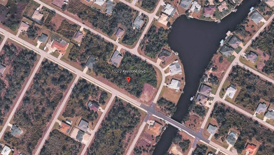 Build your Florida dream home on this well-located residential lot at 13372 Keystone Blvd in Port Charlotte. Situated in an established and growing area, this property offers a great opportunity for homeowners or investors looking to secure land in a desirable Southwest Florida community. The lot provides ample space for a custom home while still allowing room for outdoor living, a pool, or landscaped surroundings.
Public utilities are available in the area, adding convenience and long-term value, and the property is located on a paved road with nearby newer construction, reflecting continued development and demand. Enjoy the benefit of a neighborhood that offers flexibility, with optional HOA participation typical for the area, making it appealing for those seeking fewer restrictions.
Conveniently located just a short drive from U.S. 41, the property offers easy access to shopping, dining, medical facilities, and everyday necessities. Gulf beaches, waterfront parks, boating, fishing, and golf courses are all within reach, allowing you to fully enjoy the Southwest Florida lifestyle. Nearby major roadways also provide straightforward access to Punta Gorda, Port Charlotte, and surrounding coastal destinations.
Whether you’re planning to build now or hold for future development, this lot presents a solid opportunity in a steadily expanding area of Port Charlotte. Don’t miss the chance to invest in your piece of Florida living and start planning your next chapter today.