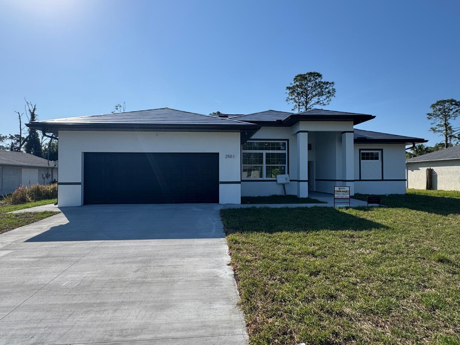 Under Construction. Great incentives - Seller credit up to 12,000 to be used towards closing cost or rate buy down. Beautiful home for sale in North Port, FL, featuring 4 bedrooms, 2 bathrooms, a gourmet outdoor area, and cutting-edge technology that offers savings and an exceptional lifestyle. This property includes an 8kW Tesla solar roof, providing an average of $200 monthly savings on electricity bills, with integrated solar tiles backed by a 25-year warranty. It also features a private well for water, eliminating water bills, and a smart energy panel that allows real-time monitoring and remote control of energy usage via smartphone, offering greater safety and efficiency. Located in one of the fastest-growing cities in Florida, known for its outstanding quality of life, proximity to Gulf Coast beaches, natural parks, and warm mineral springs. Best of all: no HOA and no CDD, giving you more freedom and lower monthly costs. A unique opportunity for those seeking comfort, technology, and savings in a highly desirable area**Ask about our preferred lender program