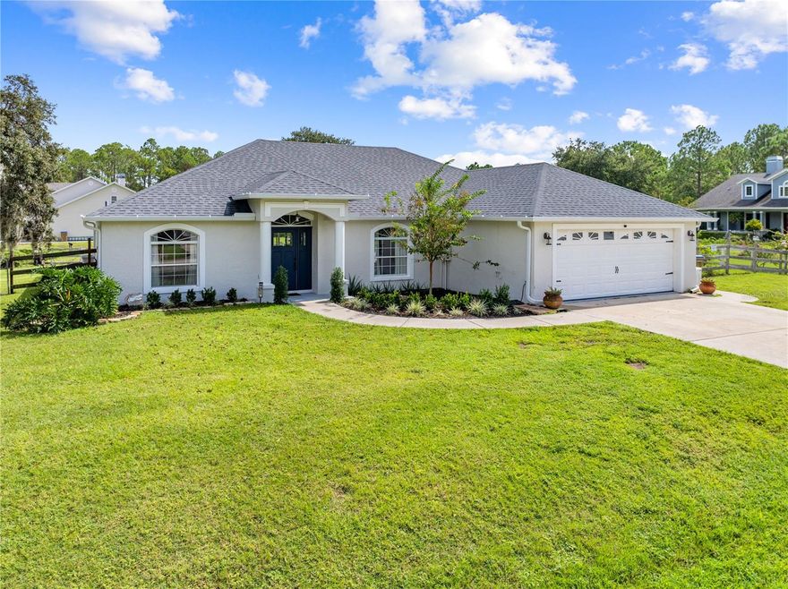 CHECK IT OUT! This 4-bedroom, 2-bath home sits on a spacious ½-acre lot with no HOA — giving you room to breathe and freedom to live your way. Step inside to a fresh white kitchen with granite countertops, stainless steel appliances, and tile flooring that ties the space together beautifully. The split floor plan offers privacy, while new flooring and updated lighting bring a modern touch throughout. The Mater bedroom has a beautiful feature wall and boast a master bathroom with double sinks and a walk-in shower. Enjoy peace of mind with a newer roof, A/C, and water heater — all the big-ticket items are done! Out back, unwind on your screened paver porch or host a BBQ on the extended paver patio overlooking the fully fenced yard. There’s even a covered carport, perfect for keeping your toys or boat out of the weather. Conveniently located just minutes from a public boat ramp for the Alligator chain of lakes and about 45 minutes from Orlando International Airport and the theme parks, this one checks all the boxes for comfort, convenience, and value. Bring your toys, your family, and your dreams — this home is ready for it all!