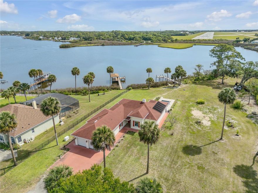 Direct Intracoastal access waterfront 3-bedroom, 3.5-bath, 1.25 acre property on Turnbull Bay.  It offers a private dock, screened in private pool, and beautiful bay views. Built in 2018, this single-story home features 2,586 square feet of heated living space and an attached 2-car garage. The home offers an open floorplan with high ceilings, a split-bedroom layout, a primary bedroom on the main floor, inside laundry, and a spacious waterfront kitchen that opens to the main living areas. Get your popcorn! There is a screened in private theatre room, making it ideal for everyday living and entertaining. Exterior features include an in-ground pool, screened in patio area, mature landscaping, and direct waterfront dock access to enjoy waterfront boating, kayaking and fishing. No HOA.
