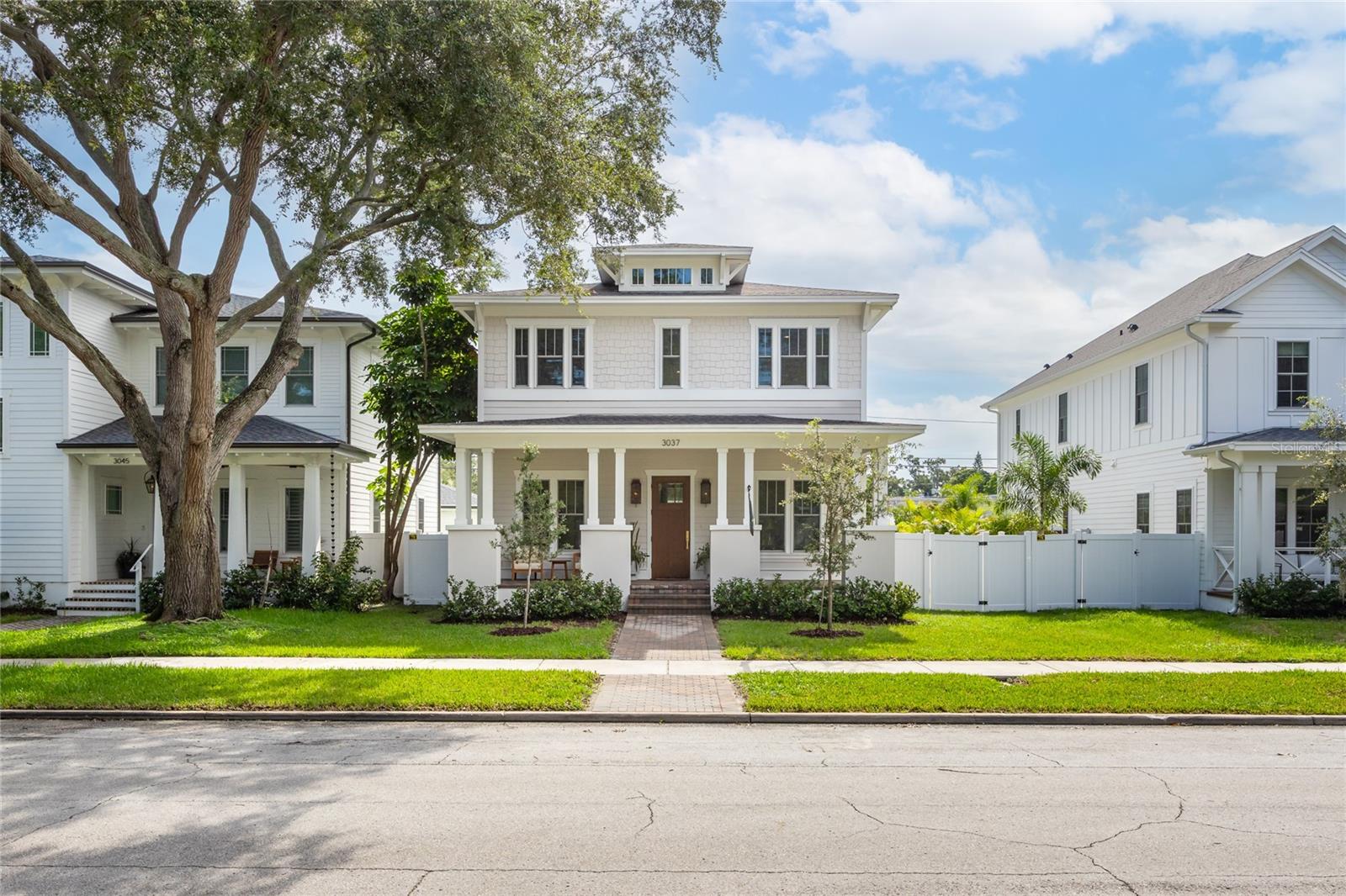 Why wait for new construction when this professionally designed 2023 Canopy Builders home is move-in ready today?
Nestled in the sought-after Magnolia Heights neighborhood, this Four Square model sits on a premium 6,200 SF lot high and dry in Flood Zone X. Built by one of St. Petersburg’s most acclaimed builders, no detail has been overlooked in this 4-bedroom + office + loft, 3-bathroom residence with a detached 2-car garage with an electric charger.
From the moment you arrive, the timeless curb appeal shines with Hardie Board plank siding, impact-rated windows and doors, gas lanterns on the welcoming front porch, and a pavered walkway framed by canopy oaks. Inside, 10’ ceilings on the main level, 8’ solid interior doors, and a designer finish package set a sophisticated tone.
The open-concept floor plan flows effortlessly from the living area to the chef’s kitchen—complete with a spacious island, quartz countertops, top-stack cabinetry, and a KitchenAid appliance suite featuring a 36" natural gas range. Perfect for entertaining, the home also features front and rear porches and a backyard large enough for your dream pool and outdoor retreat.
Upstairs, you’ll find a versatile loft, a laundry room with custom cabinetry, quartz counters, and a sink, along with abundant storage. The primary suite is a true sanctuary with a spa-like bathroom offering a freestanding soaking tub, dual vanities, a glass walk-in shower, and a spacious walk-in custom closet.
Everyday convenience meets style with impact windows, 9’ ceilings upstairs, and thoughtful touches like custom lighting and built-in storage.
Location is everything—and this quiet, tree-lined street puts you minutes from Downtown St. Pete, Crescent Lake, coffee shops, restaurants, and the beaches.
Move-in ready, expertly designed, and built to the highest standards—this is the Magnolia Heights home you’ve been waiting for.