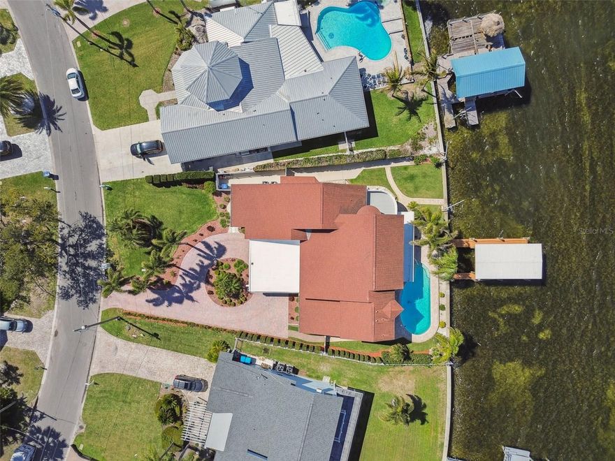 EXTREMELY RARE OPPORTUNITY to Own Your Gulf-Front Dream Home on Indian Bluff Island. This unique island is home to just 168 properties. Situated in the highest phase of the community, 119 Carlyle Circle is a rarity, as it is one of the few homes on the island with DIRECT UNOBSTRUCTED VIEWS of St. Joseph’s Sound and Gulf of Mexico. This spectacular 4-bed/4-bath home spans 3,500 sqft. of open-concept living and affords flexibility to easily customize or expand space on upper and lower levels. Immediately, you’ll be captivated by this home’s abundance of NATURAL LIGHT, soaring ceilings, and elegant wooden staircase. With WATER VIEWS FROM NEARLY EVERY ROOM, the main floor is the hub of the home and perfect for entertaining. The CHEF’S KITCHEN has custom maple wood cabinetry with under cabinet lighting and art-stained glass inserts hand crafted by an HGTV artist! Entertaining is no problem with the generously sized island, and bountiful counter space. New matching GE appliances add functional elegance. The kitchen opens up into a BRIGHT AND SPACIOUS LIVING ROOM. Floor-to-ceiling windows and sliders provide spectacular views of the pool and water. This area is flanked with 2-beds/1 full bath on one side, and 1-bed/1 full bath on the other - the perfect layout for a private retreat for family, friends or another 1st-floor primary suite! Completely UPDATED LAUNDRY room with brand new washer/dryer, upgraded custom laundry vanity w/black stainless-steel sink and faucet. PLENTY OF STORAGE! Just off the laundry room you’ll enjoy the convenience of your OVERSIZED, SIDE ENTRY, 2-CAR GARAGE w/two large storage closets, built-in workbench, generator hook-up and double electrical panel w/room to add more circuits. Upstairs, your PRIVATE PRIMARY BEDROOM SUITE offers more wide open views of St. Joseph’s Sound. Your sanctuary comes complete with a private sitting area, lifetime composite sundeck, generously sized en-suite bathroom w/ jetted soaking tub, sauna, walk-in shower w/built-in seat and private water closet. Adjacent to the primary suite, is an ADDITIONAL UNFINISHED LOFT SPACE (approx. 1,000 sqft) with vaulted ceilings and window that can easily be transformed into more space for the primary suite, additional bed/bath, office or media/game room. Professional landscaping, lighting and pavered driveway and contemporary portico make this home’s CURB APPEAL UNDENIABLE.  Boating enthusiasts will love the COVERED DEEP WATER DOCK and remote-controlled 10,000 lb BOAT LIFT featuring brand new stainless-steel motors. Watch the red-orange glow of the sunset over the water from your pool lanai with access to FULL POOL BATH. New marcite, pool pump and raised filter ensure you’ll enjoy your pool for years to come! LOVINGLY MAINTAINED by its long-time owners, this home is secure and private with IMPACT WINDOWS, DOORS & GARAGE DOOR, aluminum fascia, vinyl fenced enclosed backyard and owned security system. Recent upgrades include: Three new ACs (10-yr warr), Fleck water softener, upgraded electric service entrance, and hot water heater (12-yr warr), neutral paint, 6-panel doors, modern trim, ceiling fans and upgraded low-voltage lighting for added ambiance. Indian Bluff Island residents gather for traditions like the annual fishing tournament and other holiday celebrations. Minutes from Pinellas Trail, Wall Springs Park, and Innisbrook Resort with four world-renowned golf courses. These homes do not come up for sale often - Schedule your private showing today!