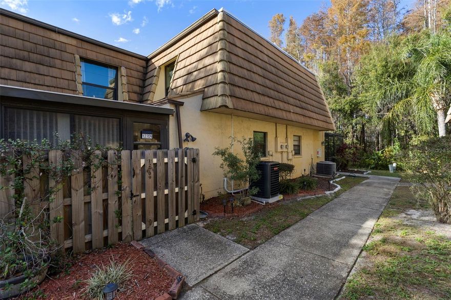 Are you looking for a stylish and comfortable townhome in the Citrus Park area? The Townhomes of Country Run are conveniently located in west Tampa, near the Veterans Expressway, with easy access to Tampa International Airport, local shopping malls, theaters, parks and tons of dining choices. This townhouse has the only fully enclosed and finished oversized sunroom, with an outdoor storage closet.  With windows on two sides, you can enjoy the sun and relaxation in this bonus room. Sliding doors open into the Kitchen to expand your living space.  The living room is spacious, and also has sliding doors to the sunroom.  Just off the kitchen is the laundry room with the half-bath.  Upstairs, two complete suites are available, each with walk-in closet and ensuite bathroom with tub/shower.  Updates include: New hurricane windows were installed on the ground floor and upstairs, the roof was replaced 2024, and new 30-year warranty roof coating over the sunroom was done 2025. Indoor and outdoor carpet in sunroom was replaced November 2025; new kitchen sink and faucet 2025, along with new garbage disposal. A new vanity was put in the half bath. Entire interior was repainted Fall 2025. A new Air Conditioning unit was installed December 2025 and new living room flooring.  The work has been done for you!  Come see this delightful, comfortable, and convenient townhome!