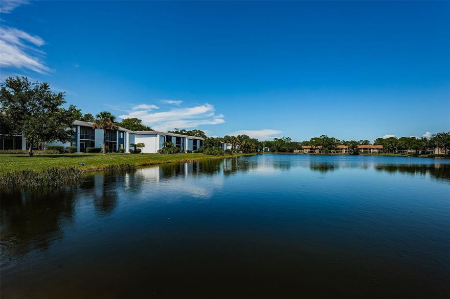 Updated and remodeled first floor end unit condo in the Woodlake Run area of gated East Lake Woodlands Country Club Community. This beautiful condo has luxury vinyl plank flooring thru out. Foyer entrance takes you past the hallways for primary and guest bedrooms into the living area with side window, sliders out to the glass enclosed tiled lanai overlooking the two acre pond. Custom made breakfast bar leads the way to your updated kitchen with custom designed newer cabinets and countertops. The washer and dryer are located in the utility closet off the kitchen and the front lanai is also enclosed. The primary suite has two closets and sliders out to the enclosed lanai overlooking the pond, along with remodeled bath. Guest bedroom with small slider out to the front lanai and guest bath has also been totally remodeled with shower only. The community has two heated pools and assigned parking. This is a non smoking/vaping residence and the owner prefers no pets please. Water, sewer, trash, basic cable and internet is included in the rent.